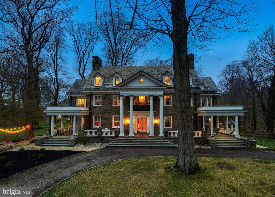 Designed by the Philadelphia firm of Savery & Scheetz for its wealthy industrialist namesake, the Houstonia mansion impresses at every turn. No detail was spared in this 22-room estate - you'll find all of the grace and charm of the time period intact with tasteful and modern updates, making the home both a lovely endeavor in preserved history and well-suited for today's discerning buyer. With an incredible amount of original architectural elements whose quality in craftsmanship and detail is a rarity in today's builds, the home is quintessentially Neoclassical. Ascend the bluestone terrace with Juliet balcony & soaring 2-story portico & discover its grandeur. French doors open onto a magnificent reception hall, whose wide stair & Palladian window half-story landing fills the space below with natural light. Gleaming hardwood floors, handsome wainscoting, detailed millwork, pocket doors, stunning light fixtures & quality materials set the tone for this home.  A very large, full-depth living room with gorgeous soapstone hearth fireplace is located to the hall's left. It serves as a lovely gathering room, providing access to both the terrace & sunroom. To the right of the center hall, you'll find the office & an arched passageway to the home's beautiful dining room with a second soapstone hearth fireplace. The generously-sized butler's pantry with beverage refrigerator, a second dishwasher and abundant storage is adjacent, followed by the kitchen with gorgeous cabinetry, stainless steel built-in kitchen aid appliances, huge island, and many gourmet amenities! A  mudroom is located just beyond the kitchen & makes a lovely transition to the back stair hall and side porch entry. The stairs provide convenient & informal access to the bedroom wing above; here you'll find 5 bedrooms, a den, 3 full baths, laundry room & stair access to the 3rd story. Continue across the main stair hall to find the sizable owners suite with en suite bath, large dressing room which formerly served as a sleeping porch walk-thru closets. The finished 3rd story includes a bedroom suite ideal for guest or perhaps an au pair, bonus rooms, walk-in cedar lined storage rooms, and a billiard room which now serves as a fabulous family room. A large, detached carriage house with three heated garage bays is located on a separately deeded tax parcel and is included with this property. The carriage home residence serves perfectly as an in-law suite, or a rental. With hardwood floors throughout, it boasts an eat-in kitchen, great room, family room, 2 bedrooms, hall bath and deck. With five acres of gorgeous private grounds, including a former green house, Houstonia is also surrounded by an oasis of township parkland in Wallingford. This location provides convenient access to the Philadelphia Airport, SEPTA train stations, Media Borough, and a myriad of retail and commercial centers.