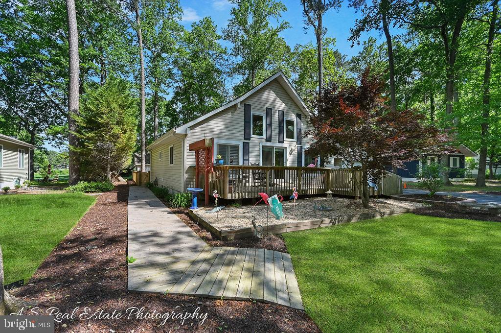 Discover charm and character in this uniquely designed 3-bedroom, 3-bath home nestled in the heart of Ocean Pines.
Offering approximately 1,936 sq. ft. of living space, this property features a spacious great room, formal dining area, and a wood-burning stove.
The upstairs primary suite boasts a luxurious walk-in California closet and a beautifully tiled ceramic shower in the en-suite bath. A separate den provides the perfect flex space for a home office or guest room.
Step outside to enjoy professionally landscaped walkways, and a temperature-controlled outbuilding—ideal for a studio, workshop, or home gym.
Additional highlights include a pantry, custom finishes throughout, and access to all of Ocean Pines’ desirable amenities. This one-of-a-kind home is truly a must-see!
