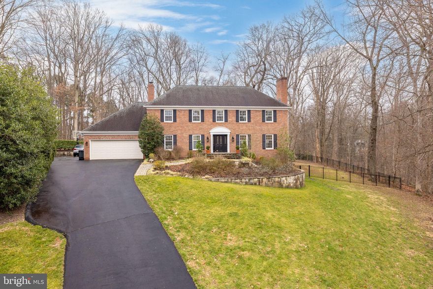 Sited at the end of a cul-de-sac, this elegant colonial offers a wooded and serene setting in close-in McLean.  This home has been updated throughout its three levels and provides a flexible and light-filled floor plan. The main level features a foyer with a curved staircase, a living room with a fireplace, a formal dining room and a gourmet kitchen with an island and breakfast area that opens to the family room with a beamed ceiling, a fireplace and access to the backyard. A mudroom connecting to the attached two-car garage and a renovated powder room complete this level. Upstairs, there is an expansive primary suite with a fireplace, ample closet space and a primary bath with dual sinks, a seamless glass shower with a bench and a jetted tub. There are three additional bedrooms and two full baths accessed from the main staircase, while an additional staircase off of the mudroom provides access to a separate bedroom suite that makes an ideal au pair room or private office space. The walkout lower level offers a large recreation room with a fireplace, an exercise/bonus room and a large storage room with a washer and dryer. The fully-fenced backyard is a peaceful retreat featuring an expansive main patio with a firepit and outdoor kitchen, a lower patio off of the  recreation room, a sports court  and mature trees. A paved path provides access to The Potomac School, while DC, Tysons and Arlington are an easy drive. Offer deadline: Tuesday, March 5th at 12 PM.