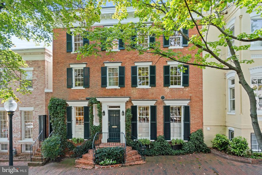 This elegant historic Georgetown residence was constructed circa 1853.  For more than 50 years, the property has been owned by an admired U.S. Secretary of State, who regularly hosted prominent Washingtonians, diplomats, and dignitaries.  Its splendid architecture and grandeur make it a fitting venue for distinguished gatherings as well as warm family affairs.  The beautifully finished interiors and expansive rear gardens exude an air of sophistication and prestige. The home boasts a large reception room and a dining area fit for stately dinners, and the oversized two-car garage makes it a perfect home for ease of access and convenient living. The house is steeped in rich history, serving as a backdrop for significant political and diplomatic events, making it a truly iconic residence in the heart of Washington, D.C. The house has a commanding street presence with a traditional brick façade enhanced with beautiful ivy, two sets of iron-railed front stairs, and detailed dentil millwork. The reception foyer and hall provide a welcoming view to the spacious terrace and lush garden.  The foyer effortlessly transitions to the double salon that affords two wood-burning fireplaces, lovely crown molding, and two sets of French doors to the rear terrace. The nearby dining room, which can be completely closed off, has built-in wooden cabinetry and conveniently accesses the exterior terrace. The gourmet kitchen has been impeccably designed and updated by noted D.C. architect, Anne Decker. It is well-appointed with marble countertops, a center island, a large pantry, and high-end stainless-steel appliances including a SubZero refrigerator and freezer and Viking six-burner range. There is also a butler’s pantry off the kitchen, which provides additional kitchen storage, as well as Miele washer and dryer. A separate garden room accesses the rear terraces and garden and is an ideal breakfast room or first floor office. This floor also has a coat closet and powder room near the front door. The second level offers a library, three bedrooms, and two full bathrooms, including the generous primary suite. The primary bedroom overlooks the beautiful garden below and includes a large double-door closet and newly renovated en-suite marble bathroom with heated floors. Both additional bedrooms on this floor are well-appointed and light-filled.  They share a hall bathroom and a large closet for additional storage. The library on this floor has walls of bookshelves and overlooks the garden. The top floor of the residence has multiple uses such as a generous bedroom suite and/or an oversized family room or office with an abundance of built-ins including a desk, shelving, and cabinetry. This floor also includes a full bathroom. The lower level of the residence provides basement storage space, multiple closets, full bathroom, a utility sink, and other utilities. The rear grounds with mature plantings, blossoming trees, brick terrace, and stone fountain are exceptionally private and wonderful for entertaining. There is also an oversized two-car garage including a full bathroom and additional space for storage and/or garden use.  The house is within walking distance to neighborhood restaurants, shops, parks, Georgetown Waterfront, and Kennedy Center.