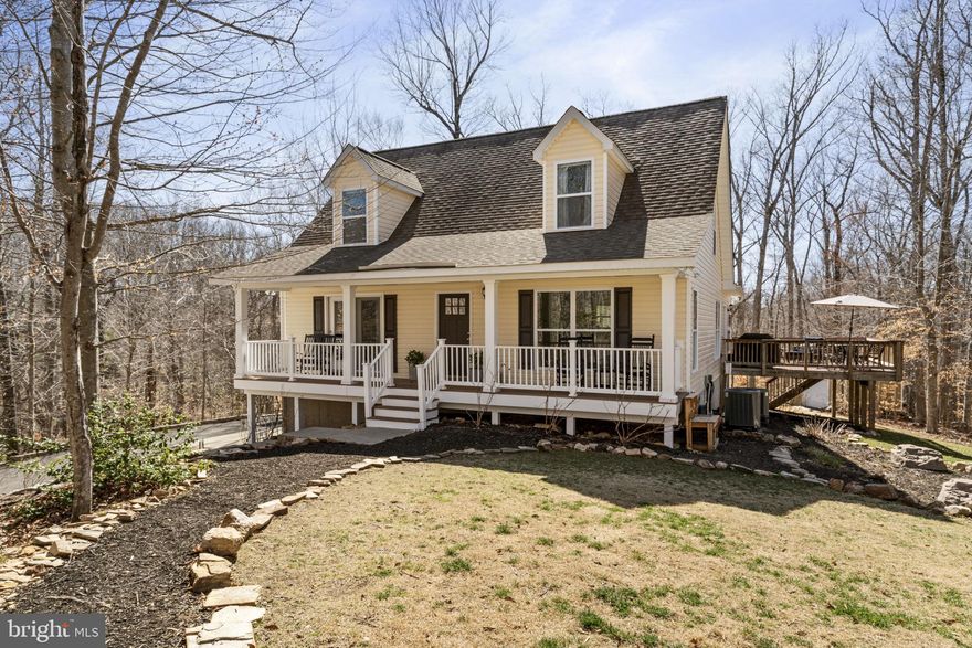 Nestled on a 3.25-acre lot in the serene Rose Run subdivision, this custom 2010 built Cape Cod home offers both community and seclusion. A tree-lined driveway leads to a side-load two-car garage and parking pad. 
The inviting covered front porch welcomes you into an open-concept main level, featuring an open kitchen complete with stainless steel appliances and a center island and a warm family room and dining room, with access to a versatile sunroom off the back.  All in a neutral and inviting paint color throughout the home! The sunroom can easily transform into a game room, gym, office or homeschooling space.​ Luxury vinyl flooring continues on the entire main level and upper level too!

The main-level primary bedroom boasts dual walk-in closets and an en-suite bathroom with a garden tub, separate shower, dual-sink vanity, water closet, and linen closet. A conveniently located mud/laundry room near the primary suite adds to the home's functionality, and the best of one level living if desired. 

Upstairs, three spacious bedrooms each feature walk-in closets, complemented by a spacious hall bathroom and several storage closets. The oversized garage accommodates full-sized vehicles and includes two additional storage areas and a workshop space. A spacious crawl space measuring 45' x 16' offers ample standing-height storage!
Step outside off the sunroom onto an 18x22' rear deck providing tranquil woodland views in summer and flashes of Abel Lake in the winter. On-site trails provide access to walk back to the lake. Don't miss the fun kids playground too in the front yard!

The potential owners will appreciate the excellent Stafford and Fredericksburg amenities, which include convenient shopping and dining, parks, pools, and Government Island Wetland Preserve, Central Park, and historic Old Town Fredericksburg. Enjoy the tranquility of this secluded setting while remaining just moments away from I-95 access and everything northern AND Central Virginia have  to offer.  Approximately a 20-30 min drive to Quantico Military Base, depending on which end. 
A 1 acre invisible fence,  charger, and  2 collars and flags for training convey. 
Both Trane HVAC systems were replaced  in 2021 and 2023.  Appliances are 2021 or newer. 
Luxury Vinyl Flooring installed in 2021 throughout the home.