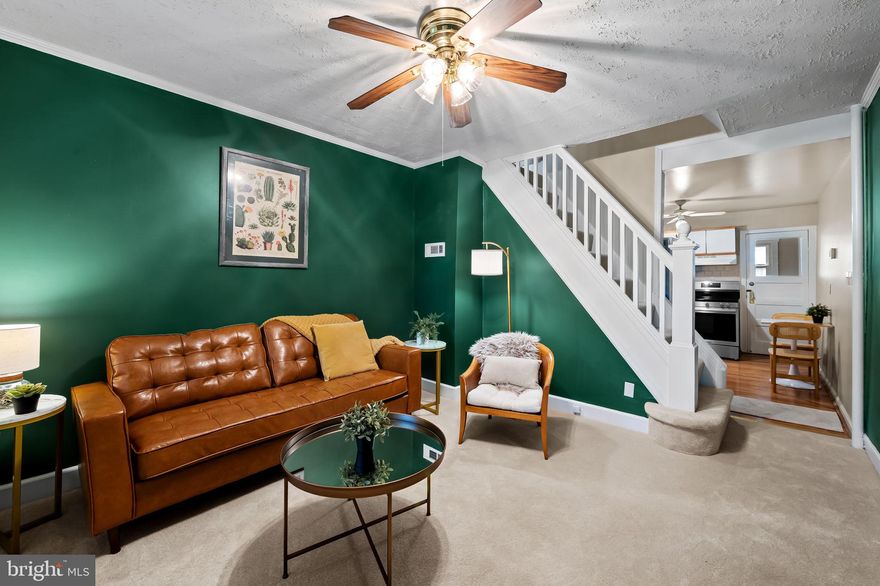 Nestled in the heart of Hampden, this beautifully updated three-story brick rowhome combines historic Baltimore charm with stylish, modern updates.  Enjoy peace of mind with brand-new updates throughout, including new windows, a new furnace, new water heater, new roof, and a brand-new front porch—all the big-ticket items are already taken care of.
Just steps from “The Avenue” and everything that makes this neighborhood one of the city’s most beloved, 3432 Roland offers a rare opportunity to enjoy walkable city living at its best.Step inside to find Open concept spacious living room as it  flows seamlessly into the kitchen, featuring new appliances including a brand new stove , and ample storage.  Cold storage rear porch functions as a pantry and mudroom helping you stay organized. Upstairs, you’ll find comfortable bedroom, closet/ dressing room or extra office space  and a full bath. The finished lower level offers flexible space for a guest room, home office, or media area, along with convenient laundry, storage, and a full bath. A ground level entrance and large windows make this feel more like main level living space than a basement and would be great short term rental opportunity. Outside, enjoy a welcoming extra large front porch, and small outdoor space in front and back. Just enough for a few plants to enjoy but not large enough to require a green thumb. Located minutes from boutique shopping, award-winning dining, and local parks, this Hampden gem offers the true charm of Baltimore living — where historic character meets vibrant community.
