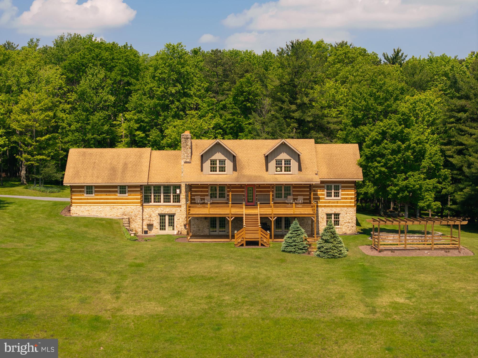 This property will truly take your breath away from the moment you pull in. The views seem never ending, no matter which way your turn, this private piece of paradise delivers. The sunrise and sunsets at this home are hard to explain just how beautiful they are. Upon entering the home, it just keeps impressing. The hearth beams and logs are stunning, the cathedral ceilings and abundance of windows make this home feel warm and inviting. Three levels of living space, a large loft area and two kitchen areas affords you plenty of room to entertain family and friends. The wood work with different species, wormy chestnut and cherry is another unique feature. The property sits on 71.65 acres which boasts a stream, pond and spring house. The attached two car and detached oversized four car garage with a loft is enough space for vehicles, tractors, mowers and side by sides. A whole house generator, radiant floor heat and an outdoor wood furnace, this home will keep your comfortable year round. The large front deck, covered porch and Pergola are perfect spots to just sit and relax and take in the scenery. A property similar to this is very hard to find in Garrett County, a hunters dream or just a private paradise to call your own. Call quickly for a tour, it won't last long!