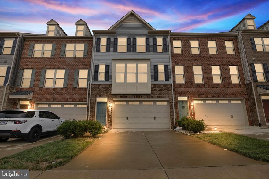 Back on the market, lucky you! The contract fell through because the buyer's home did not sell. Welcome home to this stunning 3 bedroom, 3.5 bathroom, 2 car garage luxury townhome with over 3,000 sq ft of living space! The main level living area features hardwood floors, recessed lighting and an abundance of natural light from multiple large windows. The gourmet kitchen is a dream to work in with a large preparation island with chic pendant lighting, stainless steel appliances including a double-door refrigerator and dual wall ovens and ample cabinetry and countertop space. Double sliding glass doors in the dining room lead to the partially-covered back deck - an ideal spot for outdoor entertaining! This level is completed with a convenient half bathroom. On the upper level you will find the spacious primary bedroom with hardwood floors, walk-in closet, and private en-suite bathroom. This bathroom features a soaker tub, glass shower, and dual sink vanity. Two more bedrooms with closet space, a full hallway bathroom, and a convenient laundry closet complete this level. The finished walkout lower level features ample space for additional family room or recreation room. This level also has a full bathroom making it an ideal place to set up guests as well. The 2 car garage features a Tesla charger and the home is centrally located in a neighborhood only minutes from downtown Manassas, the VRE, 28 and 66. Don’t miss the opportunity to make this beautiful place your home!