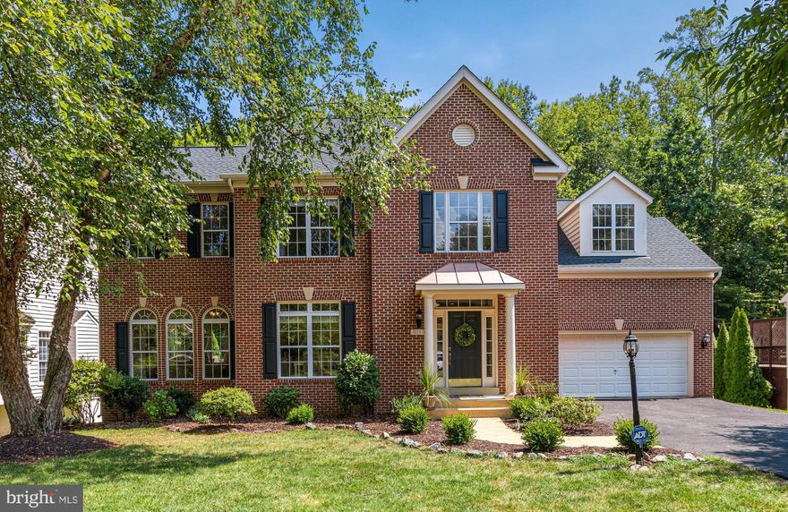 Warm and welcoming brick-front colonial with contemporary flair is sited at the end of a deep cul-de-sac AND backs to the paved Willow Pond trail that follows the Little Rocky Run tributary. Enjoy year-round seasonal views and valued backyard privacy from the sun deck and lower patio. The interior doesn't FEEL traditional with its high ceilings, arched room entries, columns, and knee-wall accents. Smart NEW upgrades are the cherry-on-top! New roof, new kitchen appliances and granite countertops, 3 levels of on-trend flooring and paint, new lighting + more! Primary bedroom has grand floor space and a deep walk-in closet. Its en-suite bath offers a dual sink vanity plus a dressing table and corner soaking tub. A rare en-suite bedroom has its own shower bath plus two other bedrooms share a full hall bath - a perfect solution for busy mornings! Full walk-out Recreation Room for party over-flow or casual fun. 16x14 Den is the flex space for guest room (full bath access), office, or fitness. This home delivers in living space and is loaded with the amenities buyers seek today. Ashton Wells is a small enclave of homes tucked off the beaten path but easily accessible to dynamic retail (Fair Lakes), excellent public education, renown higher education (GMU), and public amenities and parks. The charming Town of Clifton. dating back to the 1850s, is just minutes away.
