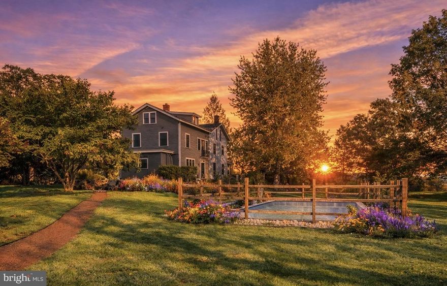 3307 Windy Bush Road—an elegantly refreshed Bucks County estate offering a rare harmony of historic character, natural beauty, and contemporary comfort. Ideally located just minutes from downtown New Hope, this private retreat is set amid idyllic grounds featuring a newly installed saltwater pool, a fully restored and climate-controlled studio, curated gardens, and a thoughtfully converted barn—capturing the essence of refined country living.
Beyond the threshold, the main residence reveals a seamless blend of timeless charm and inspired modernization. Bright, airy rooms flow effortlessly, showcasing newly restored hardwood floors, charming architectural details, and striking windows that frame breathtaking views of the surrounding landscape—enhanced by all-new landscaping designed to open sightlines and highlight the property from every angle.
The avant-garde kitchen is a true showpiece, appointed with sleek cabinetry, new Italian marble countertops, a brick backsplash, and new appliances. Perfectly integrated with inviting dining and living areas, the space is ideal for both everyday living and stylish entertaining. All bathrooms throughout the home have been fully renovated, reflecting a cohesive blend of luxury and modern design.
The primary suite is a serene sanctuary, featuring a private dressing area, a romantic Juliet balcony, and a luxurious marble bath complete with a soaking tub and glass-enclosed shower. Two additional bedrooms share a completely new Jack-and-Jill bathroom, while the top floor unveils exceptional bonus space—three generous rooms with a full bath—perfectly suited for guest accommodations, home offices, or creative pursuits.
Outdoors, extensive upgrades elevate everyday living, including stone walls and walkways, a fenced garden, a newly constructed driveway, a whole-house generator, and professionally redesigned landscaping that enhances privacy while showcasing panoramic views from every vantage point.
The renovated barn offers remarkable flexibility, featuring an impressive new kitchen, a bedroom with poolside views, and an updated full bath with laundry—making it an ideal guest retreat, entertaining venue, or extended living space for friends and family.
Just beyond, the third structure, a restored studio with heating and air conditioning provides a versatile environment for artistic endeavors, a gym, home office, or private wellness retreat.
Together, the elegant main residence, turnkey barn, and restored studio form an exceptional Bucks County estate—rich in character, private yet connected, and beautifully situated within the esteemed New Hope–Solebury School District. Moments from the cultural heart of downtown New Hope and enhanced by meticulous improvements, this country-chic compound affirms that true refinement does indeed have an address.