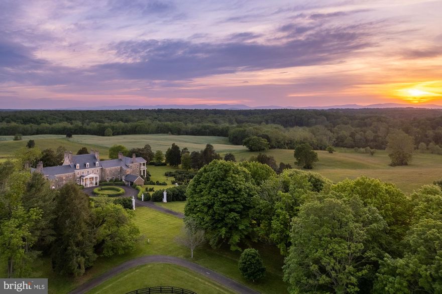 Experience unparalleled privacy at the magnificent North Wales, established circa 1713. This breathtaking Fauquier County property spans 1,482 acres of rolling fields, forest, lush formal gardens, and features a historic, stunning Georgian-style manor house located only an hour from Washington, D.C.

Enter through the stately gated entrance on tranquil Springs Road, where a gatehouse marks the beginning of a gently winding 1.5-mile drive. This scenic journey, flanked by rolling hills, ponds and picturesque stone bridges, culminates in the arrival to the exquisite manor house, set along a signature maple tree-lined driveway. Originally built circa 1776 and thoughtfully expanded in the early 1900s with the expertise of nationally renowned architects Arthur Little and Herbert W.C. Browne, the manor boasts of 22 bedrooms, which include 12 dedicated staff quarters. Grand living, dining, and ballrooms make it an ideal setting for entertaining, while the estate’s design prioritizes privacy and offers breathtaking views.

The extensive primary suite includes adjacent sitting rooms and a kitchenette, complemented by a stunning terrace overlooking the rolling hills and pastures. North Wales features eight residential tenant dwellings, including an exquisite carriage house with a five-bedroom apartment, horse facilities, tranquil ponds, and sweeping views of the Blue Ridge Mountains. 

Protected by a conservation easement with the Virginia Outdoor Foundation, the estate allows for the creation of additional private recreational facilities, such as a world-class equestrian operation or a nine-hole private golf course. As one of America’s great estates and a national treasure, North Wales is proudly listed on both the National Register of Historic Places and the Virginia Landmarks Register.