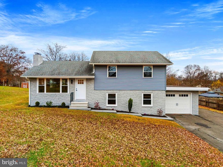 Fully Renovated and Move-In Ready! Discover a beautifully rehabbed multi-level home that seamlessly blends modern amenities with timeless charm. This stunning residence offers the perfect combination of comfort and style just across from Pottsgrove High School and Ringing Rocks Elementary School. The beautifully refinished hardwood floors add an air of elegance and sophistication to the entire home. The main level boasts a fully renovated kitchen equipped with shaker cabinets, granite countertops, and a generously sized island. Enjoy recessed lighting, pendant lights over the island, and brand new stainless steel appliances, including an electric range, microwave, dishwasher, and refrigerator. This bright and open kitchen is perfect for meal preparation and entertaining. Main level also boasts a wood burning fireplace in the living room. The upper level features three bedrooms, each with refinished hardwood floors, overhead lighting, and an abundance of natural light from new windows. A brand new full bathroom showcases a ceramic tile floor and a tiled shower/bathtub. The lower level includes a spacious laundry room and a large family room featuring dimmable recessed lighting. The completely updated bathroom offers floating shelves and a tiled shower, along with new vinyl plank flooring throughout. Comfort and efficiency with the newly installed central A/C with heat pump provides year-round comfort and energy-efficient dual heating. Existing oil heat is complemented by brand new baseboard heater covers throughout the home. A smart Wi-Fi home climate control unit has been installed, along with a new Tyvek home wrap beneath the new siding for maximum energy efficiency. All new energy-efficient double-hung windows and replaced exterior doors enhance the home’s aesthetic appeal while improving insulation and security. A newly installed garage door with remote access and newly replaced interior doors, including closet doors, augment convenience. A barn door has been installed in the basement to separate the laundry room from the unfinished area. You will enjoy the outdoor space with the newly installed vinyl siding that not only elevates the home's curb appeal but also ensures durability against the elements. A spacious backyard presents endless possibilities for outdoor entertainment, gardening, or simply unwinding in your private oasis. The front yard has been beautifully landscaped with two sizable flower beds, while a large backyard shed offers additional storage for tools, outdoor equipment, or recreational gear. Additional storage available in the easily accessible attic space. A convenient one-car attached garage provides space for your vehicle and extra storage options. Don’t miss your chance to make this home yours and embrace a lifestyle of comfort and convenience. Seller is also the listing agent. Schedule a viewing today and step into your new haven!