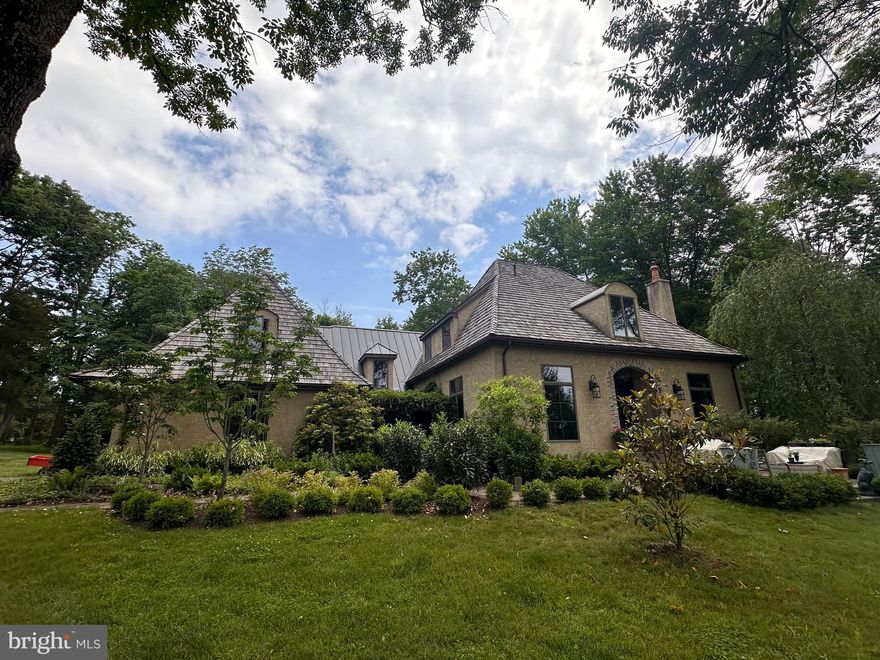 Exquisitely designed by renowned architect Jack Arnold, Deux Cheminees sits majestically on over 4 acres of picturesque landscape, offering unmatched privacy and natural beauty in one of Upper Bucks County's most coveted locations. Nestled at the highest point in Tinicum Township, this exceptional property boasts a captivating blend of European-inspired architecture and modern luxury.

Upon arrival, a charming approach and winding driveway guide you to this distinctive residence. The interior features soaring ceilings, exposed beams, intricate wood moldings, and a breathtaking barrel-ceilinged foyer that sets the tone for the home's elegance. The centerpiece gourmet kitchen, meticulously redesigned in 2021, showcases top-tier finishes, coffered ceiling, and meticulous attention to detail.

Twin wood-burning fireplaces grace both the swanky living room and gathering room, complemented by floor-to-ceiling windows that invite natural light and panoramic views of the surrounding landscape. The main level primary suite offers spa-like indulgence, highlighted by a newly renovated (2022) bathroom featuring a freestanding soaking tub, rainfall shower, and two expansive walk-in closets. Juliet balconies off the suite provide serene vistas of the property's natural splendor.

Upstairs, generously sized bedrooms include two connected by a 2022 Jack and Jill bathroom, plus a large office or private guest or teen suite. Outside, an oasis of wildlife, mature trees, and lush plantings frame a large off-kitchen deck and huge bluestone patio, perfect for intimate outdoor dining or grand entertaining under the starlit sky.

The lower level offers a versatile space with a separate entrance, ideal for extended stay guests or as an in-law suite, ensuring both comfort and privacy.

Located just a few scenic miles from polo fields, art galleries, and Delaware River towns, with their charming shops and top restaurants, Deux Cheminees offers the ultimate weekend retreat. Conveniently positioned 90 minutes from Manhattan and 60 miles from Philadelphia, it combines the allure of a peaceful countryside escape with the amenities of a luxurious full-time residence.