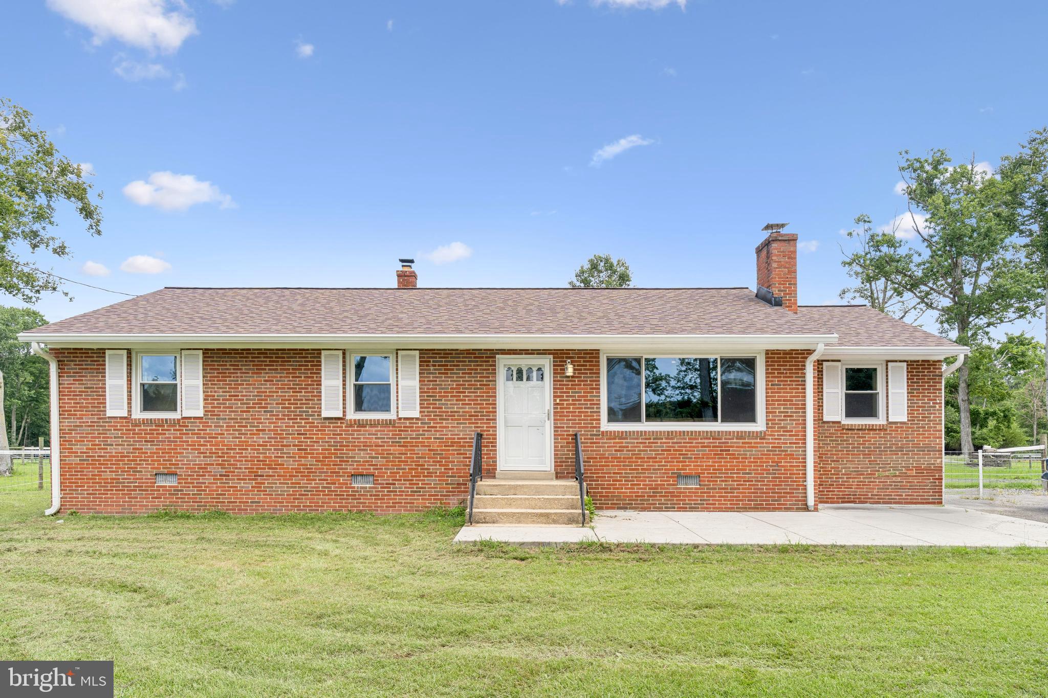 Enjoy the perfect blend of rural tranquility and urban convenience in this beautifully renovated 4-bedroom, 3.5-bath ranch-style farmhouse, ideally located on a leased horse farm just 20 miles from Washington, D.C., and minutes from Alexandria. Whether you're commuting or working remotely, this unbeatable location offers flexibility and lifestyle in one. Set well back from the road for privacy and quiet, this spacious one-level home features over 1,700 square feet of bright, airy indoor living space. The open-concept layout showcases exposed beams, brand new flooring throughout, and a welcoming living room with a wood-burning stove and a large bay window that fills the space with natural light. The fully updated kitchen boasts crisp white cabinetry, stainless steel appliances, and ample space for cooking and entertaining. All three full bathrooms have been tastefully renovated with ceramic tile and modern finishes. Additional upgrades include replacement windows, a brand-new roof, central heating and cooling, and in-home laundry. Outside, enjoy a large fenced-in backyard perfect for pets, play, or gatherings, plus a spacious front yard with plenty of parking.