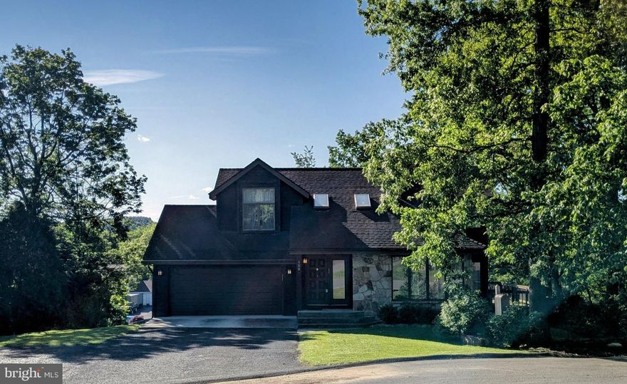 Nestled amidst the picturesque landscapes of Frostburg, this charming home offers a serene retreat with breathtaking mountain views on a quiet cul-de-sac in Braddock Estates. Enjoy ample living space with 5 bedrooms and 5 bathrooms.  Relax on the large deck located off of the kitchen, perfect for enjoying the fresh mountain air. 
The main floor features a newly remodeled kitchen that opens to the living room and dining room. The living rooms vaulted ceilings and skylights make the space light and bright! The pantry and powder room are located just off the kitchen and lead to the oversized garage! The main floor master is just down a private hallway! The master bedroom includes 2 walk in closets, with laundry hook ups, a 5 piece master bathroom and a dressing room. The master also leads out to the deck. 
The second floor overlooks the living room and has 3 spacious bedrooms and 2 full bathrooms. 
The walk out finished basement is all of the bonus space anyone could need! Storage, bonus rooms, bedrooms, office space, playroom, entertainment space..... the possibilities are endless. 
The large private backyard is fully fenced and provides a shed for yard maintenance equipment or a workshop. A large stone area with a fire pit make the perfect cozy outdoor space. If you like to garden you can enjoy the new raised bed built just last summer. All of the landscaping is annual! In the spring the yard will be framed by hostas, leafy trees, and evergreens. The yard had the perfect balance of sun and shade! The cement patio under the deck provides an additional shaded entertaining space and has two entrances into the basement.