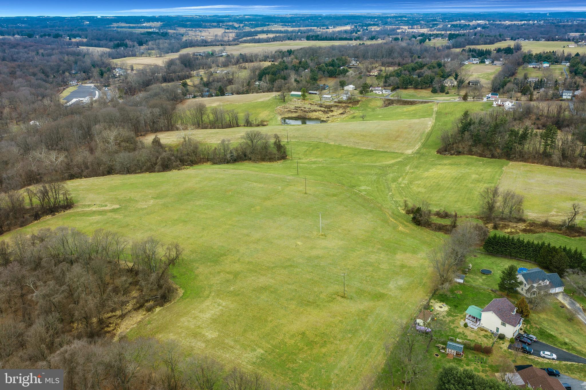 Located in close proximity to the Fair Hill NRMA is this 81+ acre working farm that consists of 26 acres of crop land, 30 acres in hay, and 25 acres of mature woodland. The property has a 3 bedroom 1.1 bath, detached three story rental property with a good history of rental income, a 60'x40' pole barn, a 40'x20' corn crib as well as additional outbuildings. The property has a 1/2 acre man-made pond and boasts over 600' of total frontage along the Little Elk Creek. With road frontage on both Providence Rd and Singerly Rd, the possibilities with this property are endless. Whether you are looking for farmland, a site for an equestrian facility that is convenient to Fair Hill or for potential development opportunities, this property should not be missed. The parcel is zoned Northern Agricultural Residential (NAR), and has a subdivision potential for up to 4 lots through minor subdivision, and 7 lots through major subdivision beyond that. Call to schedule a showing today.
