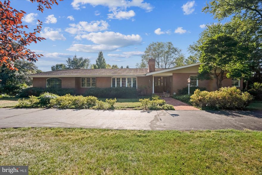 Private and inviting, this sprawling ranch home sits on a 1.36-acre landscaped lot with exterior features that include a circular driveway, oversized side-entry two-car garage, mature trees, impressive landscaping, a screened porch, bi-level deck, covered patio, and even a koi pond! Step into a very spacious main level covered in hardwoods and bathed in natural light. Featured attractions on this level include: three bedrooms, two and one-half baths, an updated kitchen with tasteful white cabinetry, a center island, granite counters, walk-in pantry, and adjoining breakfast room. A front living room with a large bay window and beautiful stacked stone wood-burning fireplace. The family room is anchored with a 2nd fireplace on this level which opens to the yard. An additional entertainment space, set up as another bedroom, is complemented by built-in bookcases and a custom wet bar with cabinetry. The large lower level offers a generously-sized recreation room with a wood-burning fireplace, a second den / potential fourth bedroom, and a third full bath. This impressive property provides abundant space, a stunning treed lot, excellent storage space, owned solar panels, and easy access to major commuter routes and local schools.