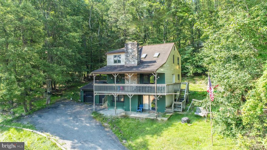 Perched above the treetops with panoramic lake views, this three-level retreat blends comfort with clean, considered upgrades. Vaulted ceilings and a spacious loft crown 2,235 square feet of living space, wrapped in new flooring with fresh paint inside and out. The kitchen, smartly updated with new countertops, connects to open dining and living anchored by a wood stove. A detached garage sits off the drive; while the private deck draws the eye to the water. An established rental, “Views and Brews” is being sold fully furnished and ready to go. Just minutes to marinas, Wisp Resort, and the lake’s best bites. Call today for details!