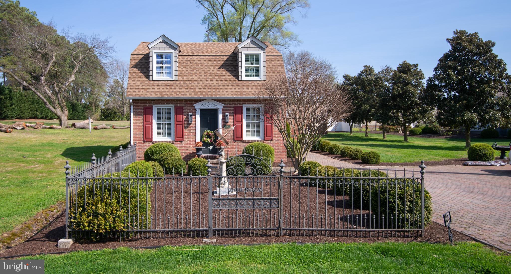 Improved pricing ! Cambridge - charming brick carriage house with water rights! Larger than it looks - 1800 +/- sq. ft. - 3 BR, 2 1/2 bath home just outside city limits (no city taxes!), but still close to all the shops and restaurants of down town. Beautifully maintained with hardwood floors, cool architectural details, Two living spaces and first floor bedrooms. Newer stainless appliances and roof. Amazing hardscape with brick patios in the front and back yards, large brick wall, and wrought iron fencing (upkeep is minimal - mostly perennials) Many accents in the yard are included. Cute outbuilding. Lots of history to share about this property- all this and the water rights just around the corner!