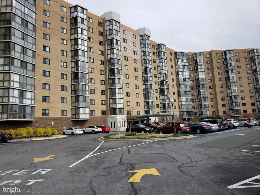 Age 55+ Active Adult Community.    GARAGE SPACE #5-12 is INCLUDED in the Sale Price!!  
You will be greeted by a welcoming atmosphere as you enter this beautifully rennovated condo.   Updated LVP flooring in the Living and Dining rooms along with  Large Neutral walls provide the perfect canvas for your personal touches.   When needing a respite, you'll surely enjoy spending time on the enclosed balcony featuring a magnificent view of the pond and fountain at the front of the building . . . (by the way,  it is lighted in the evening).  The Tablespace Kitchen has been enhanced with updated white cabinetry and stainless appliances.   The carpeted primary bedroom is located to the right of the living/dining room and has a remodeled ensuite bathroom with walk in shower and a large custom designed walk in closet.   Let's not forget the 2nd bedroom with ensuite bathroom that is located  on the opposite side of the living room and equipped with the same brand LVP flooring . . . a perfect guest suite that could double as an office, den or craft room.   All closets in the home are custom designed.    Extra storage located on the lower level - Storage Room #1 - Bin #59 conveys.   Storage Room is located  in close proximity to Garage Parking Space. #5-12.  Treat yourself to the many amenities this Active Adult Community has to offer . . .  18-hole golf course,  Indoor & Outdoor Swimming Pools, 2-Club Houses, Restaurants, Fitness Center, Computer Center, MedStar Medical Center, Tennis Courts, Pickleball,  Woodworking Shop, Travel Agency and over 100 clubs and organizations.  Time to pack your bags and head our way!!