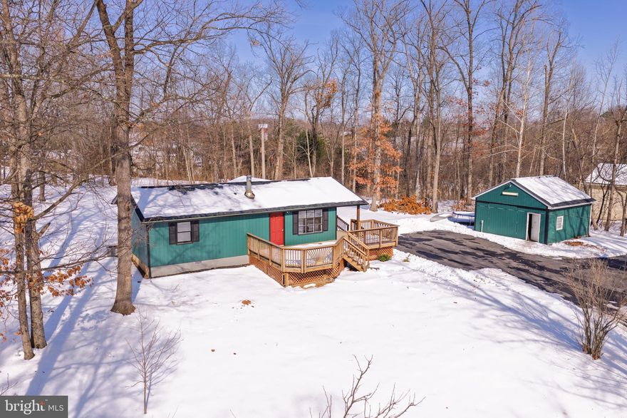 Offered for sale is this charming ranch-style home with a detached garage/shop situated on just over an acre with no HOA!! This is the perfect home for anyone seeking a little more space and privacy than most properties at this price point typically offer. The home has a new roof and gutters recently installed. The HVAC system was installed approximately 5 years ago, and the water heater is approximately 2 years old. The woodstove does a fantastic job heating this home, which can significantly reduce winter electric bills. The covered, screened-in rear deck is a great place to relax or entertain guests. The shop/garage is insulated and has electricity and heat.  This space has many potential uses, including a mechanic's shop, gym, studio, workshop, man cave, game room, golf simulator, etc. Schedule your showing today to see what this property has to offer!