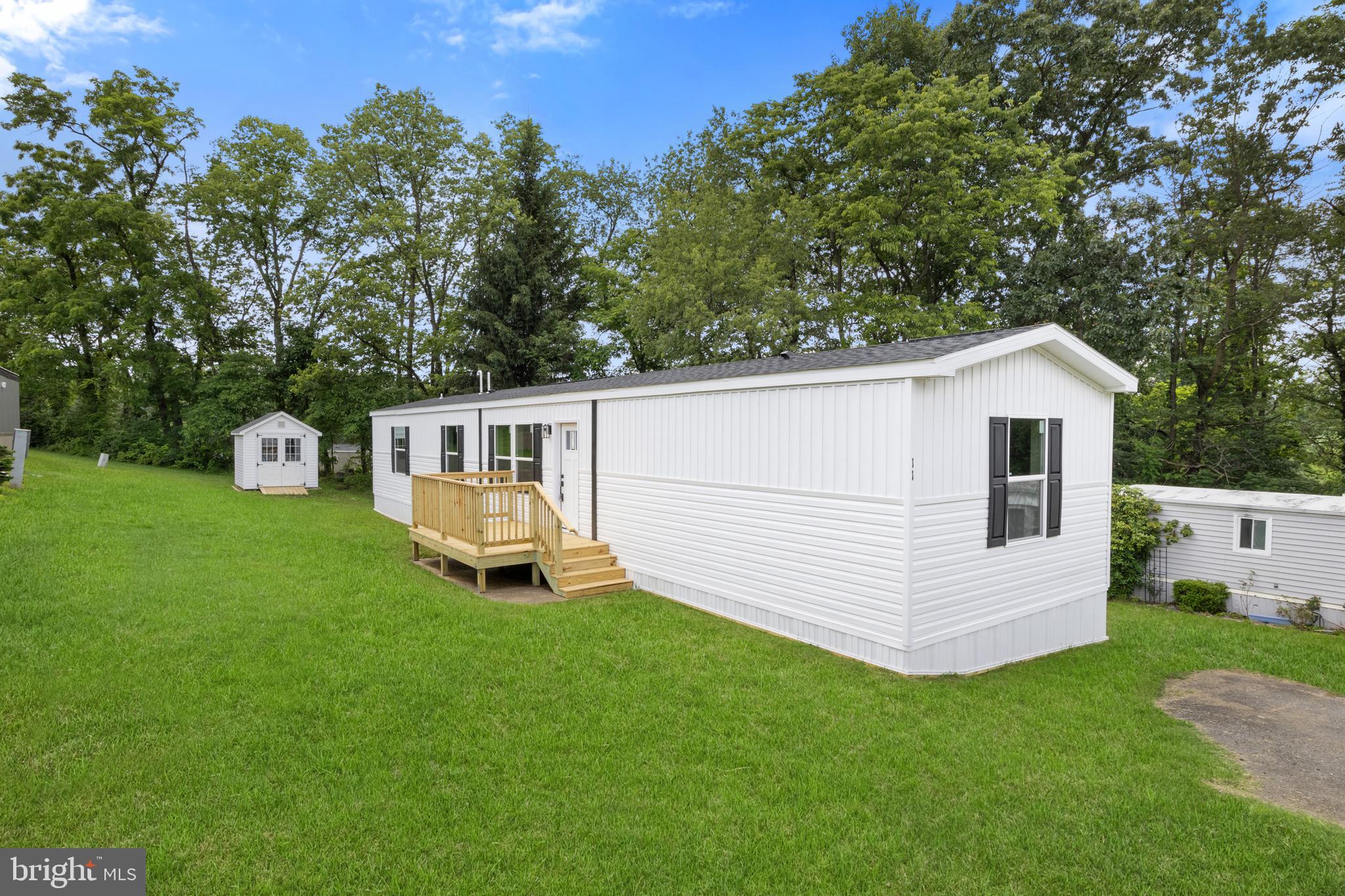 Welcome to your brand new mobile home in the Margaretta MHP Community! Nestled in a beautiful and secluded location within the Eastern York School District, this home offers both privacy and convenience. As you step through the front door, you'll be greeted by an open layout that creates a spacious and inviting atmosphere. The kitchen boasts tons of cabinet space, tastefully designed to accommodate all your cooking needs. The living room features an accent wall, adding a touch of charm to the space. With 3 bedrooms and 2 bathrooms, there's plenty of room to relax and unwind. Plus, washer dryer hookups make laundry day a breeze. This home is E Built, which means it is 30-50% more energy efficient then other manufactured homes. Insulation, Energy Star appliances, specialized water heater and windows all contribute to its energy efficiency. This home is also Zero Energy Ready which means it can be connected to solar or wind easily. Outside, you'll find a brand new 8x10' Stoltzfus A Frame Shed with Cupola included with the home, providing ample space for all your storage needs. One year limited home warranty included with the sale. Don't miss out on the opportunity to make this beautiful mobile home yours. Call today to schedule a tour! *Central AC can be added for an additional $5000*