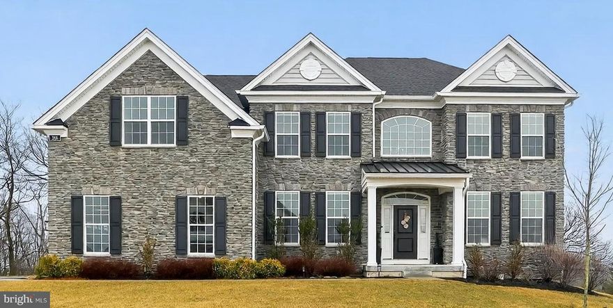 This beautiful home is only available due to a job relocation. Situated on a premium elevated lot in the highly sought-after Preserve at Kimberton Glen, this exceptional Duke Heritage model offers the elegance of new construction without the wait. A striking stone façade provides timeless curb appeal and introduces the beautifully appointed interior. A grand two-story foyer with a sweeping wood-tread staircase welcomes you inside, where gleaming hardwood floors extend throughout the main level. Formal spaces flank the foyer, with an elegant dining room to the left and a refined sitting room to the right (currently used as a playroom), offering flexible living options. The dramatic two-story great room features soaring ceilings, a gas fireplace, and a wall of windows that fills the home with natural light. Open to the great room, the gourmet kitchen includes quartz countertops, a large center island with seating, stainless steel appliances, custom tile backsplash, soft-close cabinetry, a custom silverware drawer, concealed trash receptacle, and a walk-in pantry. A sunlit dining area overlooks the backyard, while a thoughtfully designed mudroom and laundry room add everyday convenience.
A desirable first-floor bedroom suite (currently used as an office) includes a full bath, ideal for guests or multigenerational living. Upstairs, the luxurious primary suite features a private sitting area and spa-inspired bath with soaking tub, oversized shower, dual vanities, makeup area, and a private water closet. Three additional generously sized bedrooms include a princess suite with a walk-in closet and en-suite bath, plus a hall bathroom, ensuring comfort and privacy for family and guests. The expansive walkout basement with high ceilings and rough-in plumbing offers endless potential for future finished living space or continued use as a recreation area. Outdoors, enjoy a private backyard with sweeping views from this premier lot. The flagstone patio and outdoor kitchen create the ultimate entertaining space, perfect for summer gatherings and even watching Fourth of July fireworks from home. Conveniently located near Routes 422, 202, and 29, the PA Turnpike, and downtown Phoenixville—voted the #1 Best Small Town to Live in the U.S. by Travel + Leisure in 2025—this exceptional home offers luxury, space, and location in one remarkable package.