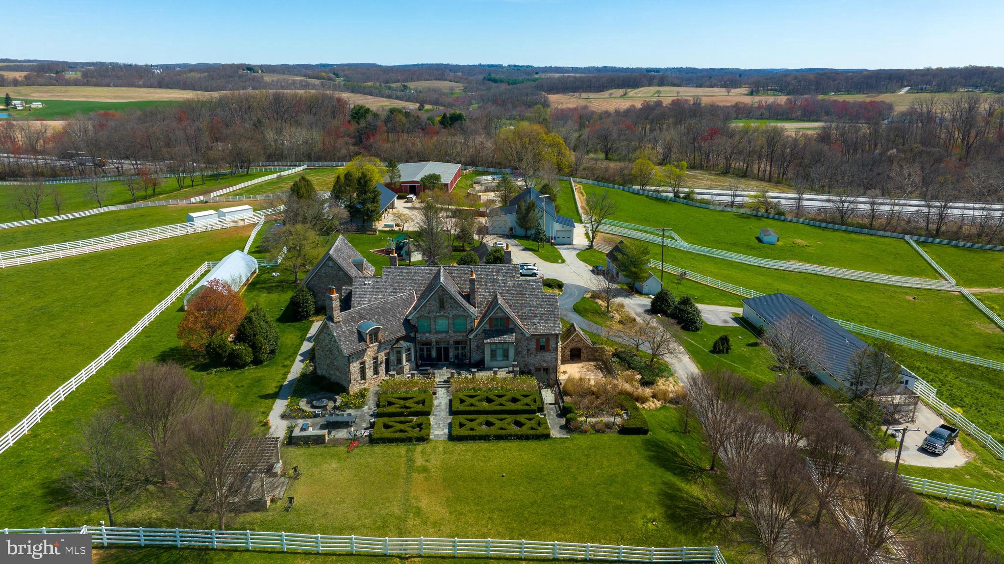 67+ Acre Equestrian Estate in Southern York County. Only minutes to Maryland! 61 stalls, fenced in pastures with run in sheds, horse barns, wash room, tack room & outdoor riding rings to host shows & a two story barn with two 2nd floor apartments. Luxury living awaits you in this 7000+ sqft custom built stone home featuring 6 bedrooms, 4 full baths, and 3 half baths. Custom details shine throughout the home such as high ceilings, crown molding, built-ins and floor to ceiling windows with wonderful views. Executive Den with beautiful wood work, fireplace, and custom wet bar that leads into the first floor master suite. The master suite features a luxury bath with jacuzzi tub and walk-in shower with dual shower heads. Formal dining room, large two story great room and open to the gourmet custom kitchen that includes Wolf appliances - 2 sub zero refrigerators, granite countertops, wood beamed ceilings and breakfast bar. Up the second floor from the dual staircase is 4 additional bedrooms, jack and jill bathroom, full bath & private office. The lower level is top notch to include your own private theater and game room. Mini kitchen with granite countertops and appliances allow for a perfect entertaining area. Double sided floor to ceiling stone gas fireplace will keep you warm on those chilly evenings. Custom gated entrance with a private tree lined driveway and expansive rear patio overlooking the fenced in pastures. Plenty of additional space for your farm equipment, trailers & hay storage. Several possibilities with everything this Estate has to offer!
