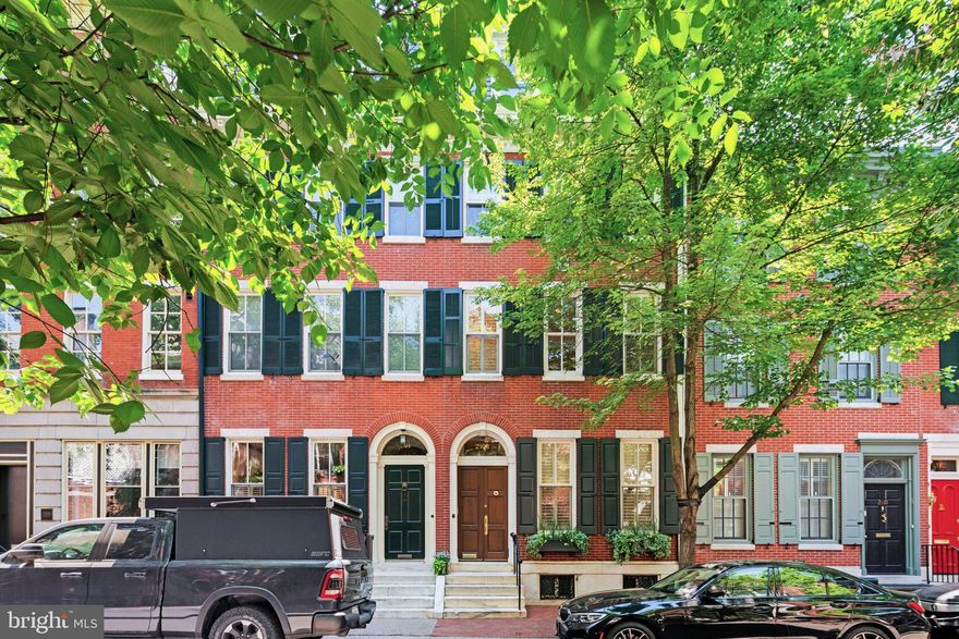 Exquisitely restored, elegant residence located on one of the most beautiful streets in the Rittenhouse Square Historic District. ONE YEAR PRE-PAID PARKING. This light filled, spacious, classic townhouse includes original moldings, archways, wood floors throughout, leaded glass windows, elegant and original straight staircase and high ceilings, combined with excellent mechanical systems throughout. This home has been totally renovated and exceptionally maintained. Excellent floorplan has formal LIVING ROOM with decorative fireplace, crown moldings and POWDER ROOM. Deluxe COOK'S KITCHEN with large center marble island, stainless steel appliances, including GE Monogram gas stove, GE monogram microwave and dishwasher. Custom wood paneled SUB-ZERO refrigerator/freezer and polished granite countertops. Custom cabinetry with wood and glass paneled doors provide excellent storage. Built-in window seat and leaded glass windows. Open archway leads to charming DINING ROOM/FAMILY ROOM with South-facing windows and French doors to lovely patio with direct gas line Weber grill. Access to large finished basement, utility room and large cedar closets. Original spindle straight stairway leads to 2nd floor. Impressive large LIVING ROOM/FAMILY ROOM with leaded glass windows. Laundry room with LG washer/dryer and butler's pantry conveniently located on the 2nd floor. The primary bedroom is located 3 steps up with large double walk-in-closets and en-suite marble bath with double shower. The 3rd floor has 3 bedrooms - one is very large with a pitched cathedral ceiling, skylights, recessed lighting, en-suite bath and new wood deck. The 4th floor has 2 additional bedrooms, one is currently used as a home office with custom built-in desk and shelving, and a full tiled bath. Excellent closet space in all bedrooms. Additional list of improvements and mechanical systems upgrades included in the listing documents.