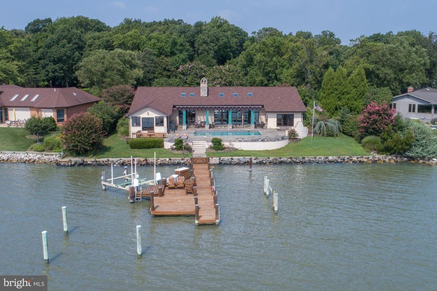 Commanding water views, waterfront pool, protected pier w/ 5 ft MLW & private setting. Light filled, one level living with open floor plan, soaring ceilings and huge views from most rooms.  Incredible entertaining space inside & out. Owners suite features bath, sitting room, office and bedroom. Kitchen and baths in need of updating.