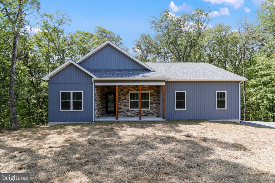 Nestled on 5 serene acres within an exclusive gated community, this future home is a harmonious blend of comfort and natural beauty. Thoughtfully designed, the residence offers three spacious bedrooms and two and a half bathrooms, perfect for modern living. A full basement offers endless possibilities.

The open-concept floor plan flows effortlessly, featuring a welcoming living space that invites relaxation and gatherings. The heart of the home is a gourmet kitchen, where you’ll prepare meals while enjoying tranquil views of the surrounding woods.

Step outside onto the covered, maintenance free back porch, where mornings can begin with a coffee in hand and evenings conclude with a beverage of your choice under a starlit sky. Designed for both convenience and privacy, this home includes a two-car garage with ample storage space.

Whether you’re hosting family or simply retreating from the world, this wooded sanctuary offers peace, luxury, and a daily connection to nature. Snag this one early to choose colors that reflect your style and create an atmosphere unique to you.