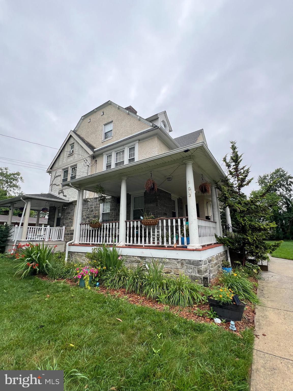 Welcome to 103 Lincoln Avenue, a stately Colonial twin in the heart of Yeadon that blends early 20th-century craftsmanship with thoughtful modern updates. Built in 1920 and spanning nearly 4,000 square feet across 4 levels, this 5 bed/3.5 bath home offers space, charm, and versatility. A classic wraparound porch welcomes you in. Inside, the main level features a spacious living room with a decorative fireplace, recessed lighting, ceiling fan, guest powder room, and a built-in bench and coat closet near the entry. The dining room is flanked by two original built-in china cabinets and opens to a breakfast area or bonus living room and updated chef’s kitchen, complete with stainless steel appliances and plenty of counter space for cooking and entertaining. Upstairs, the second level includes two generously sized bedrooms and two full bathrooms, including a spacious primary suite with a walk-in closet, a Jacuzzi tub, and a double-stall shower. The third floor offers three additional bedrooms, a full hall bathroom, a linen closet, and a cedar closet for added storage. Throughout the home, you'll find original hardwood flooring with ceramic tile in the kitchen and all bathrooms. Additional features include dual zoned central air, gas heating and cooking, and an expansive unfinished basement with full-height exterior access. Situated on a lush 0.49-acre lot, the property extends beyond the driveway to the tree line (next to 105 Lincoln), offering a flat green yard ideal for gardening, outdoor play, or quiet relaxation. The driveway can accommodate 8+ cars, making parking convenient for residents and guests alike. Located on a quiet residential block near local Yeadon Community Park and just minutes from the city, 103 Lincoln Avenue offers the perfect balance of historic elegance and modern convenience. A rare opportunity to own one of Yeadon’s grand homes with room to grow and enjoy.