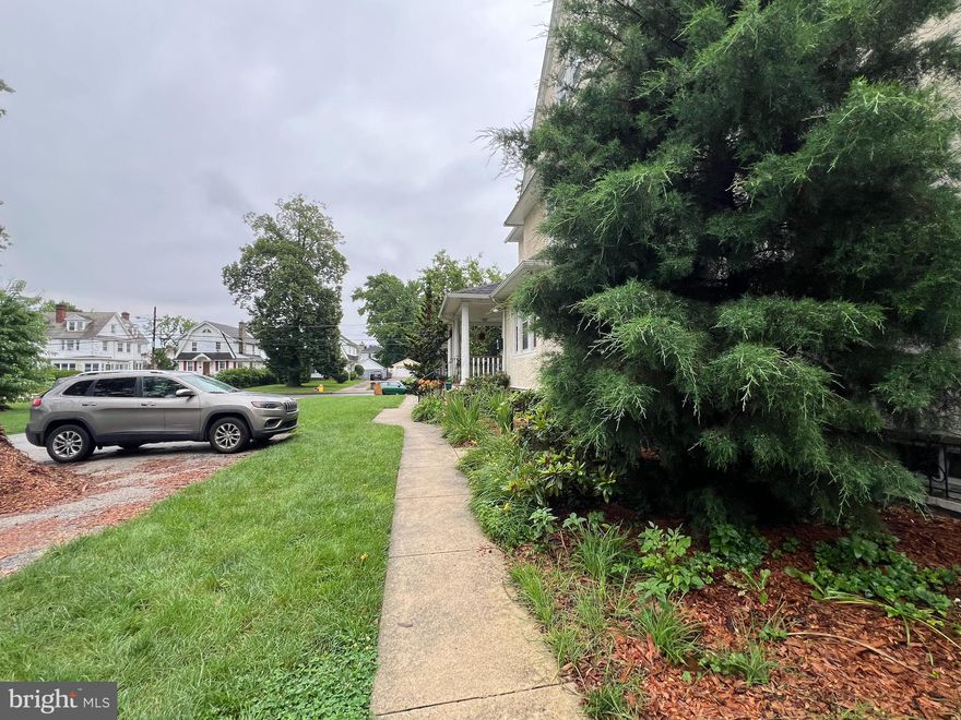 Welcome to 103 Lincoln Avenue, a stately Colonial twin in the heart of Yeadon that blends early 20th-century craftsmanship with thoughtful modern updates. Built in 1920 and spanning nearly 4,000 square feet across 4 levels, this 5 bed/3.5 bath home offers space, charm, and versatility. A classic wraparound porch welcomes you in. Inside, the main level features a spacious living room with a decorative fireplace, recessed lighting, ceiling fan, guest powder room, and a built-in bench and coat closet near the entry. The dining room is flanked by two original built-in china cabinets and opens to a breakfast area or bonus living room and updated chef’s kitchen, complete with stainless steel appliances and plenty of counter space for cooking and entertaining. Upstairs, the second level includes two generously sized bedrooms and two full bathrooms, including a spacious primary suite with a walk-in closet, a Jacuzzi tub, and a double-stall shower. The third floor offers three additional bedrooms, a full hall bathroom, a linen closet, and a cedar closet for added storage. Throughout the home, you'll find original hardwood flooring with ceramic tile in the kitchen and all bathrooms. Additional features include dual zoned central air, gas heating and cooking, and an expansive unfinished basement with full-height exterior access. Situated on a lush 0.49-acre lot, the property extends beyond the driveway to the tree line (next to 105 Lincoln), offering a flat green yard ideal for gardening, outdoor play, or quiet relaxation. The driveway can accommodate 8+ cars, making parking convenient for residents and guests alike. Located on a quiet residential block near local Yeadon Community Park and just minutes from the city, 103 Lincoln Avenue offers the perfect balance of historic elegance and modern convenience. A rare opportunity to own one of Yeadon’s grand homes with room to grow and enjoy.