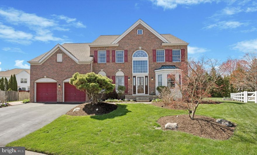 Tucked away within a quiet cul-de-sac of the Peddlers View neighborhood in Solebury Township, this colonial style home has been lovingly maintained and being offered for sale for just the 3rd time since it was built in 1996. The red brick façade with keystone accents, a high peak and large window centered over the front door, combined with beautiful landscape, the curb appeal of this home is hard not to notice! Situated on just over a quarter acre (.28), this home has nearly 3,400 SF, has 4 bedrooms, 3.5 bathrooms, and a finished basement with nearly 1,000 SF of additional living space. Through the front door, into the two-story foyer, you’ll find the living room to the right and a formal dining room to the left, both featuring crown molding for a classic touch. Follow the hardwood flooring through the foyer into the heart of the home, you’ll find an open concept living space, perfect for gathering with family, friends, and guests. The eat-in kitchen is well-appointed, featuring cherry-colored cabinets, granite countertops, a stone textured tile backsplash, and an island with stool seating for two. The laundry room is located behind the kitchen with access to the garage and back deck. The two-story great room is adjacent to the kitchen in the center of the home, has an abundance of windows providing lots of natural light throughout the day, and features a floor to ceiling stone surround wood burning fireplace. A private office/den and half bath finish off the main living level, both tucked into the back right corner of the home. Heading upstairs there are 4 bedrooms and 2 full bathrooms. The master bedroom is spacious, featuring a vaulted ceiling, 2 walk-in closets, a full bathroom with double sinks, a stall shower, and whirlpool tub. The master bedroom also incorporates a sitting/dressing area or potentially a 2nd home office/den just as it is being used currently. Bedrooms 2, 3, and 4 are all comparable in size with adequate closet space, and all share the hallway bathroom with double sinks and a tile surround tub/shower. Downstairs, the basement is finished and features a 3rd full bathroom, a separate room currently used for a small gym, a wet bar, and plenty of extra storage. The backyard is beautifully landscaped, with a wide variety of plantings throughout. The low maintenance composite deck was rebuilt in 2020 and is a great space to enjoy the outdoors. The retractable awning is perfect for when you need a little shade on hotter days. Off the deck is a paver patio, perfect for placing the grill, a firepit, or just another space to enjoy being outside. The back right side of the yard is an open grassy area where you can have a garden, swing set, or play yard games. Upgrades made by the property owner in past years include a new roof (2017), HVAC (2015), and water heater (2025). Other features of this home include public sewer/water and a 2-car garage, all in the New Hope-Solebury School District! The Peddlers View community is conveniently located adjacent to Peddlers Village, which offers guests shopping, dining, seasonal festivals, and much more!