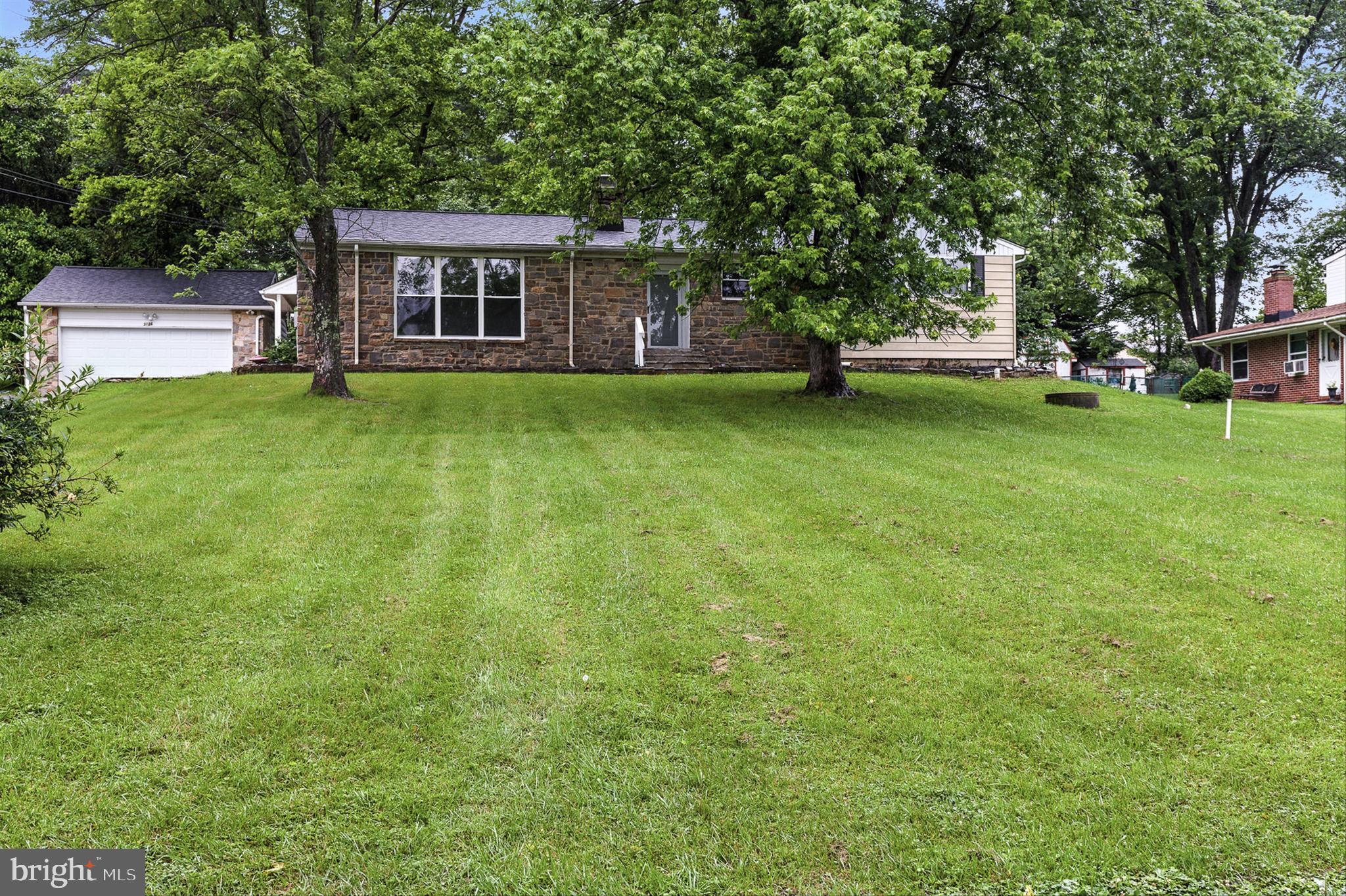 Amazing transformation on this completely renovated rancher with over 4000 square feet! This home features stone and siding exterior, brand new roof on house and detached garage, brand new sophisticated kitchen with upgraded cabinetry, quartz counters and smart appliances. Refinished hardwood floors on and bright large windows are in the great/living room and a brick wood burning fireplace, formal dining room with hardwood floors open to kitchen, 4 spacious bedrooms on the main level each with classic hardwood flooring, primary bathroom is brand new with oversized shower, hall bathroom is also new with a shower/tub combination. The lower level with chic vinyl flooring offers a 5th bedroom and 3rd full bathroom, a large family room with another wood burning fireplace and bar! New heating and cooling system installed. There is an inviting sunroom off the rear of the house overlooking the landscaped yard. One car oversized detached garage with new door. Professional photos soon!