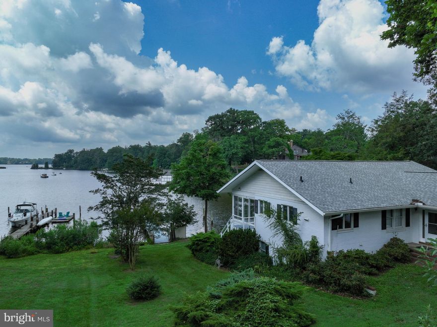 Never before sold, this home has been cared and loved by a family since it was built in 1979. Offering an expansive view, this rare waterfront beauty has deep water, 5-6-7-8 feet, and is on Crab Creek off the South River. It has 4 full bedrooms, an all seasons porch you will never want to leave, 3 full bathrooms, hardwood floors, glorious windows, built in bookshelves, wonderful solid wood kitchen cabinets. So whether you live in this home all year or have it for a family vacation home, this home is as versatile as it is functional. Back up generator will supply electricity in the event of an emergency. The dock has one slip large enough for a 40-45 single hull sailboat, or a 30' to 35' catamaran. Water and Electric to the dock. Deep water within crab creek, excellent location for sailing, kayaking, fishing and crabbing.