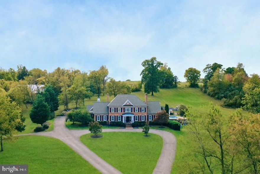 This extraordinary 5-bedroom, 6-bathroom estate sits on 14.44 acres across two parcels—5.0 acres on the front lot and 9.44 acres with the residence—just minutes from Winchester, Virginia. Designed for both everyday living and elegant entertaining, this home combines timeless style with modern luxury. Inside, hardwood floors and soaring ceilings enhance open, light-filled spaces. The recently renovated kitchen is a chef's dream, featuring a 48-inch Wolf gas range with six burners and infrared griddle, GE Monogram appliances including a pebble ice maker, and a striking quartz waterfall island with coordinating backsplash. Throughout the home, Visual Comfort chandeliers, recessed lighting, and brass Emtek hardware add refinement, while radiant floor heating on the first level ensures year-round comfort. A private gym, spacious bedrooms, and a serene primary suite elevate everyday living. All bathrooms have been updated within the last four years and now feature quartz vanity countertops. This property is made for all seasons, with three indoor fireplaces, four outdoor stone fireplaces, and a heated pool with hot tub. Expansive stone and concrete hardscaping, a hardwired exterior sound system, and professional landscape lighting create an inviting backdrop for entertaining. Practical updates include a new HVAC system (2021), a new septic system (2022), and a custom Aegis Technologies security system with exterior cameras. An attached 3-car garage plus a detached 3-car garage provide abundant parking and storage. Located just 8 minutes from Winchester Medical Center and downtown Winchester shopping, dining, and commuter routes, this home offers the perfect balance of seclusion and convenience. Don't miss the opportunity to own one of Winchester's most distinctive properties!