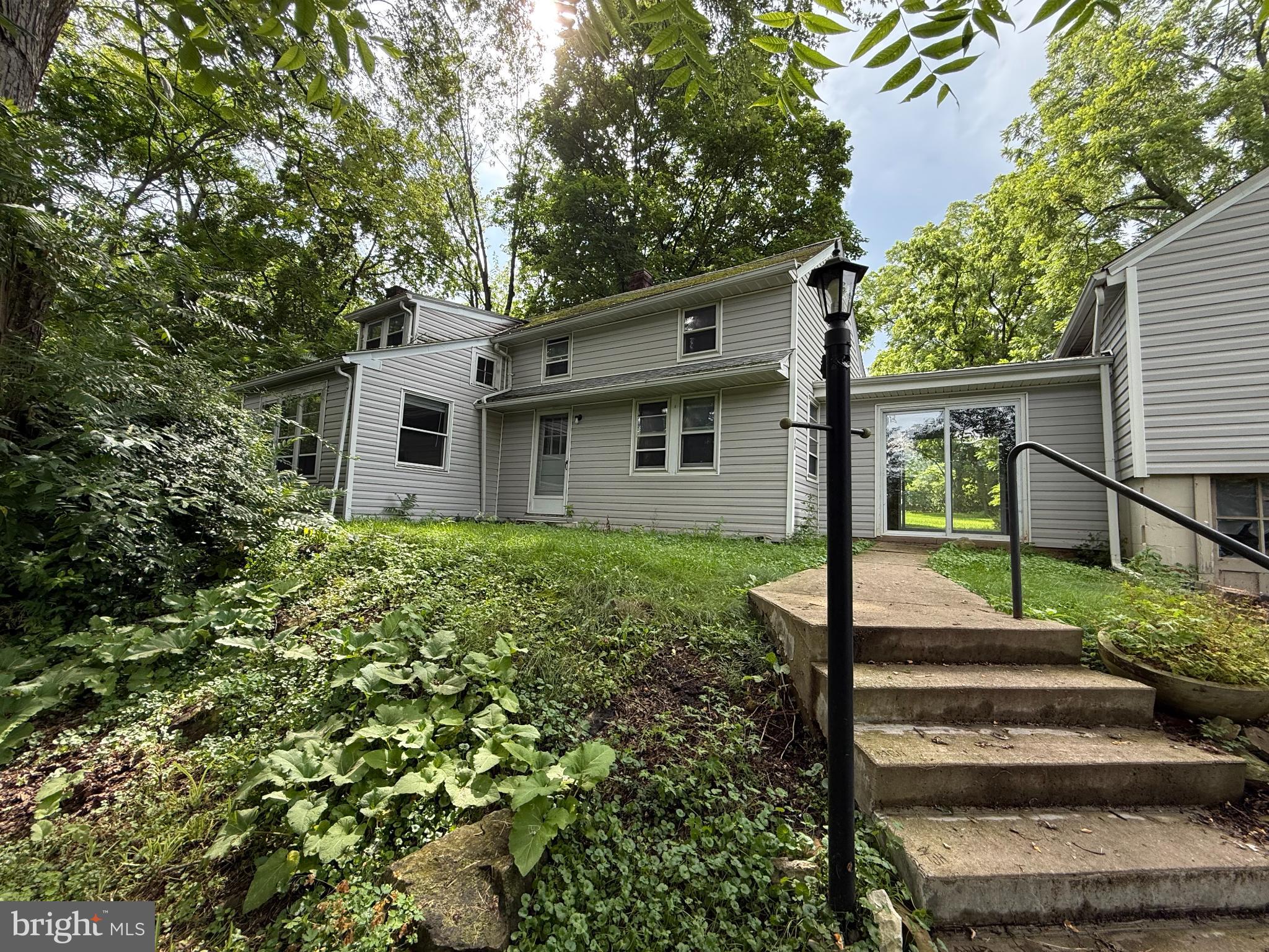 Nestled on a generous 2.48-acre lot, this charming Cape Cod-style home is unique, as it sits on a large private lot, just minutes from Downtown State College and Beaver Stadium. Built in 1930, this residence maintains some of it's original character and potential, waiting for you to transform it into your dream home. As an added bonus, there is a 1-bedroom apartment, with existing rental permit above the garage.
In the main home you will discover a cozy layout featuring hardwood flooring that adds warmth and charm throughout. The kitchen comes equipped with essential appliances, including a refrigerator and stove, making meal preparation a breeze. The expansive outdoor space offers endless possibilities for gardening, recreation, or simply enjoying the tranquility of your surroundings. Conveniently located near a bus stop (at the end of Green Acres Lane, on E College Avenue), this property ensures easy access to local amenities while maintaining a peaceful atmosphere. With no association fees or restrictions, you have the freedom to create the perfect sanctuary tailored to your needs. This property is a canvas waiting for your vision-embrace the opportunity to make it your own and experience the comfort and joy of home in a picturesque setting. Perfect fit for numerous buyers including: a single family that could have the added benefit of rental income; a Penn State 2nd home (that also would have the benefit of regular income from long-term tenant above the garage), or as an investment property to continue as a 2-unit investment property (active rental permits for both units).