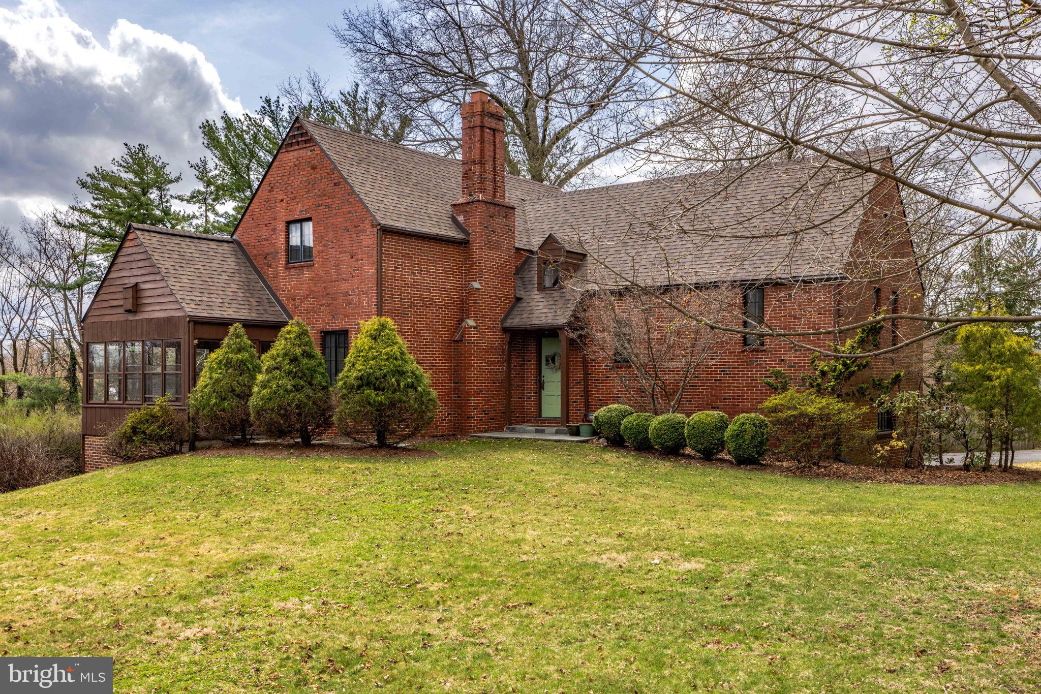 Welcome to 803 Hillcrest Lane, a beautiful 1930s Tudor-style home brimming with character and modern updates, located just around the corner from Bucknell University. Nestled on a flat, half-acre lot, this 4-bedroom, 2-bath home offers timeless elegance, thoughtful renovations, and a touch of history—Jackie Robinson himself stayed here in 1949 while a guest of Bucknell.
Step inside and fall in love with the original details that make this home truly special: gleaming hardwood floors, unpainted wood moldings and staircase, and 10-panel solid wood doors adorned with original crystal and forged iron hardware. The charm continues with a large dining room that opens to the spacious family room through original glass-paneled double doors. Cozy up by the wood-burning fireplace or relax in the L-shaped three-season porch flooded with natural light.
The renovated eat-in kitchen features vaulted ceilings, cherry-stained cabinetry, granite countertops, stainless steel appliances, a center island, and direct access to the back deck—perfect for entertaining or enjoying your morning coffee.
The primary suite boasts a walk-in closet and an updated full bath. Upstairs, you’ll find three generously sized bedrooms, an updated hall bath, and a finished attic space—ideal for a home office, playroom, or an extra storage area. The finished basement offers even more versatile space, and includes a dedicated laundry area. This home has ample storage which is a rare find in a home of this era.
Recent upgrades provide peace of mind, including a brand-new roof (2024) and a newer HVAC system and hot water heater.
Outside, enjoy a stamped concrete patio, deck and a large shed. The location is unbeatable: minutes from downtown Lewisburg, Route 15, restaurants, schools, shopping and just steps to Bucknell University.
Don’t miss your chance to own a piece of history in this one-of-a-kind Lewisburg gem. Schedule your private tour today!