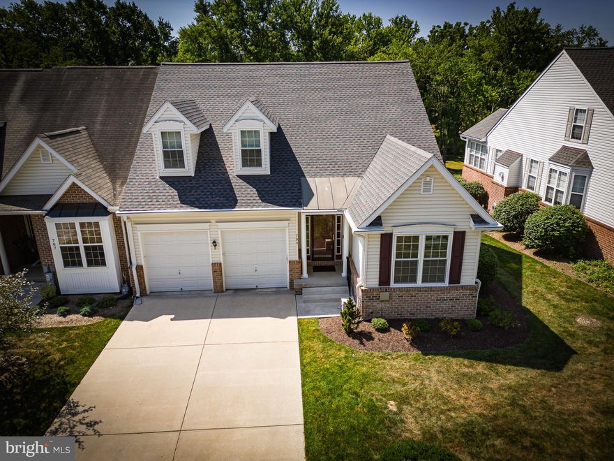 Welcome to your new home retreat! This end-of-group 2-car garage villa townhome has been meticulously maintained and is ready to move right in.  As you enter, fresh paint and new luxury vinyl plank flooring welcome you through most of the main level. Vaulted ceilings and a fireplace add to the warm setting of the main floor living room which is open to the dining room and kitchen. The versatile kitchen is open to the living room with a pass-through window and has a bright breakfast nook. The bright and airy sunroom offers 2 walls of windows, tile floor, french door access to the large composite deck offering gorgeous wooded views. The main level owner's bedroom features an en-suite bathroom that boasts a double vanity, large soaking tub, and a separate shower. An additional bedroom or office on the main level and another full bath make the layout of this home very flexible. The upper level features 2 large bedrooms and a full bath. Brand new roof and most appliances have been updated over the last 5 years, with the windows and refrigerator being replaced in 2015. In the lower level, you will be pleased with the spacious, open family room with a gas fireplace, half bath, and walk-out level with sliding door access to the tree-lined common space. Plenty of storage is also offered in the basement level.
