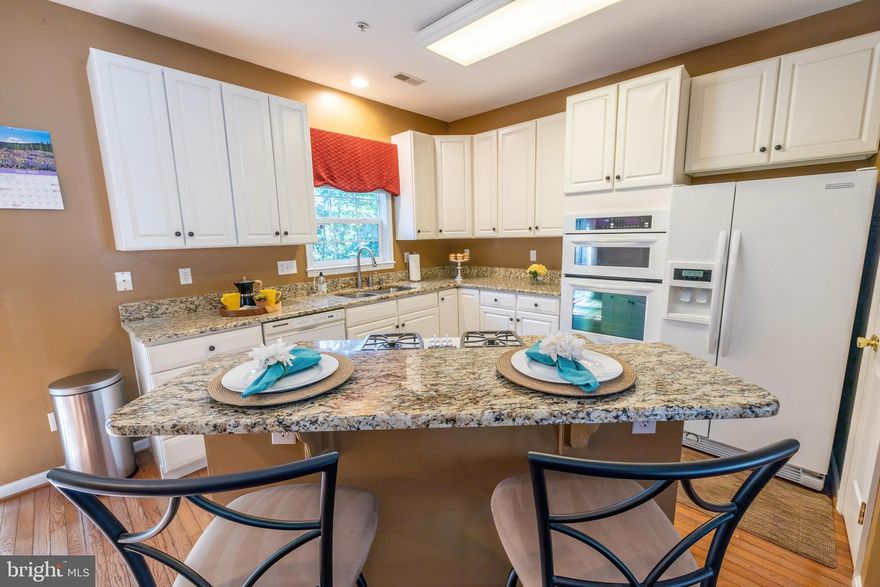 End-unit townhome in the water privileged community of Waters Edge at Woods Landing . Entry level foyer leads to a cozy family room with custom shelving  and a walk-out lower level deck. Hardwood floors adorn the second level leading to a gourmet kitchen with cook-top island, granite counters, spacious dining area and walk out to the 2nd deck. The open living room with gas fireplace is a great entertaining space. Lovely primary suite with 2 walk-in closets and a updated private bathroom with dual sinks & soaking tub. Newer HVAC systems. Conveniently located on the Broadneck peninsula with easy access to major commuter routes.