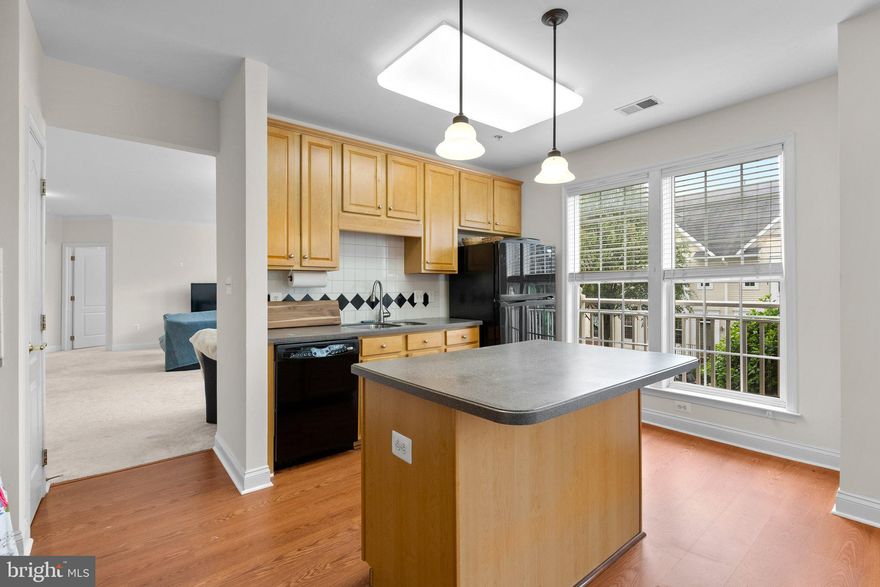 Very Spacious 2 bed,  2 bath condo, open foyer into OPEN living and dining area.  Enjoy a big Eat in kitchen with island.  This corner unit has lots of windows and natural light. Easy access to elevator.  Laundry room with storage in the condo unit. The King Farm community offers two pools (with a membership), tennis, walking and biking paths, basketball courts, a dog park, and a community center with gym. Walking distance to Safeway and the Village Center. Gated parking lot with Two assigned parking spaces #39 & #15 and plenty of guest parking. You are within walking distance to King Farm's fine dining and shops. Free Community Shuttle to/from Shady Grove Metro. Just minutes from 270, the ICC, and 355 and less than a mile to the Red Line.