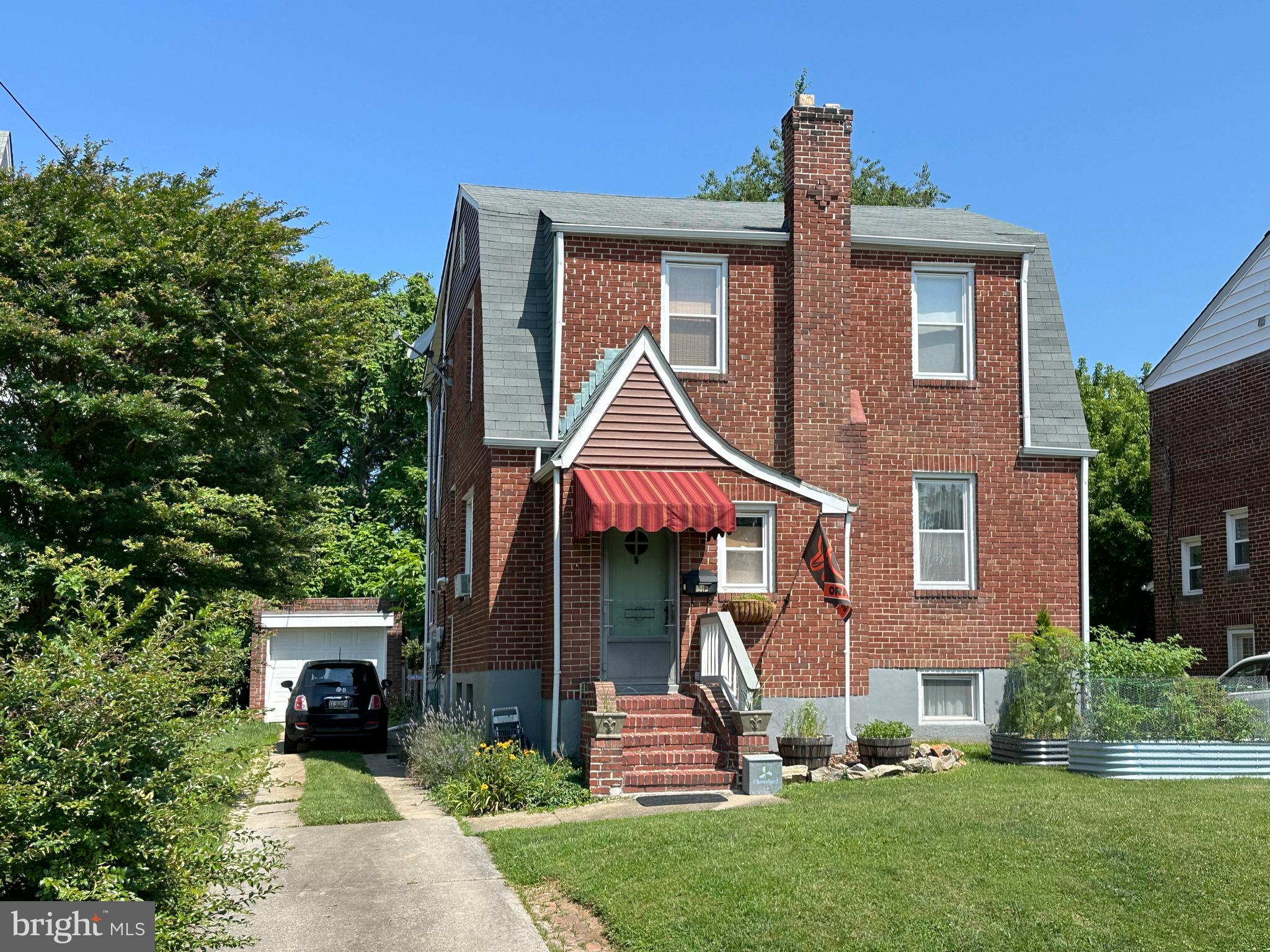 Brick colonial with 2-story addition offers many original details complemented by 21st century updates for comfortable living. The main level features a vestibule leading to a charming parlor with hardwood floors, an electric fireplace with mantel & built-in shelving, sconces, and recessed radiators. Adjacent to the formal dining room with a crystal chandelier and crown molding, the gourmet kitchen features an abundance of cabinets and food prep space with an island, granite counters, ash flooring and a breakfast nook. Just off the kitchen is a main level bedroom with pocket doors, built-in bookcases and full bath (presently used as a family room). There are three bedrooms and an office/den space on the second floor, with a classically tiled bath from the original footprint, in addition to the primary bedroom featuring an ensuite bath, bay window, dressing room & laundry. Cedar closets and pull-down attic provide an abundance of storage. The finished basement is perfect for a home theater, band practice, a gym, crafting, and more. Relax in the private backyard or on the deck and enjoy sunsets, stargazing, and over 20 species of native birds. Garage and off-street parking in driveway. Convenient to locally owned Zeke’s, Koco’s Pub, Silver Queen Cafe, Micky's Joint, restaurants, shopping & more!