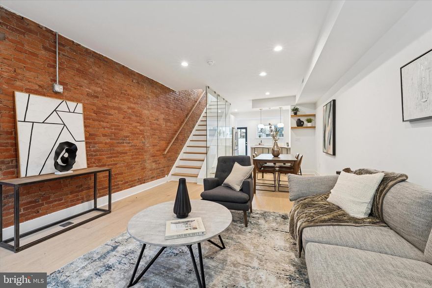 Step into 1019 Ellsworth Street—your dream on Philadelphia’s premier Passyunk Square block. This HIGH END FULLY RENOVATED  four-bedroom, three-bath stunner blends timeless exposed brick with modern magic: open-concept main floor, soaring natural light, and a jaw-dropping glass railing that frames every room. Second floor: two bedrooms, full bath. Third: first you’ll spot the luxury wet bar—mini-fridge, sink—leading straight to a covered indoor-outdoor patio. Laundry’s right there too. Then the luxury master suite: exposed brick, wooden shelving, electric fireplace, plus a huge walk-in closet that opens straight into a spa-like bathroom. Finished basement: Fourth bedroom + full bath, plus multiple smart storage areas. All closets custom-built, 10-year TAX ABATEMENT, JACKSON-COPPIN schools. Move-in perfection—rare, refined, and ready for you