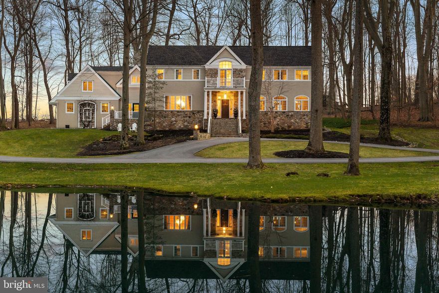 Step into luxury at Frog Hollow, an exquisite Chester County French Farmhouse crafted by renowned architect John Diament. Nestled on a tranquil 4.8-acre estate, this stunning residence offers unparalleled sophistication and comfort. As you enter the grand 2-story foyer, you're greeted by a sweeping curved staircase and lavish millwork, setting the tone for the opulence within. To the right, the formal living room boasts a gas fireplace and French doors leading to the covered Loggia, seamlessly blending indoor and outdoor living. Meanwhile, the spacious dining room offers picturesque views of the ponds, creating an elegant backdrop for every meal. A custom cherry library awaits beyond, featuring floor-to-ceiling book storage and a cozy gas fireplace, perfect for quiet evenings immersed in literature. The gourmet kitchen is a chef's dream, complete with quality custom cabinetry, granite countertops, and premium appliances by Sub-Zero, Thermador, Miele, and KitchenAid. The home's layout is designed for both relaxation and entertainment, with a hexagonal breakfast room boasting a vaulted ceiling and wrap-around windows, and a family room adorned with a two-story cathedral ceiling and a majestic Pennsylvanian stone gas fireplace. Upstairs, the master suite is a sanctuary of luxury, offering a tray ceiling, sitting area, and French doors leading to a private balcony. The marble bath is a spa-like retreat, featuring heated floors, double vanity sinks, and a soothing jetted tub. Additional bedrooms provide flexible living spaces, including a private retreat zone ideal for guests, a live-in nanny, or in-laws. The lower level offers even more entertainment options, with a media room, full bath, and wine cellar. Outside, the property is adorned with century-old trees, providing year-round privacy and tranquility. Recent upgrades including a 2020 roof, new HVAC systems, hot water heater, Timbertech deck, and three garage doors ensure modern convenience and comfort. Located less than 2 miles from major highways and amenities, Frog Hollow offers the perfect blend of secluded country living and urban accessibility. Whether you're seeking a serene retreat or a lavish entertaining space, this exceptional estate promises a lifestyle of unparalleled luxury. Schedule your private showing today and experience the timeless elegance of Frog Hollow.