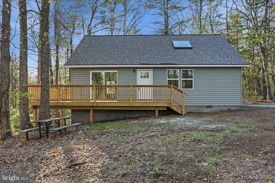 Private, secluded chalet style house on over 3 acres at the end of the road with no neighbors! Just peace and quiet surrounded by nature.  This is the one!  Would make a perfect full time residence, retirement house, second home or short term income producing rental!  This is a 2 bed 1 bath with a great layout and space and wrap around expansive deck!  Huge vaulted ceilings in the living room with skylights and plenty of room.  New kitchen with shaker cabinets, quartz counters and stainless steel appliances.  LVP floors throughout.  New lights, new bathroom, new hvac, siding, roofing, decking.  The main level offers a bedroom and the full bath and laundry; the second bedroom would be the open loft upstairs.  Check this one out and make it your getaway!