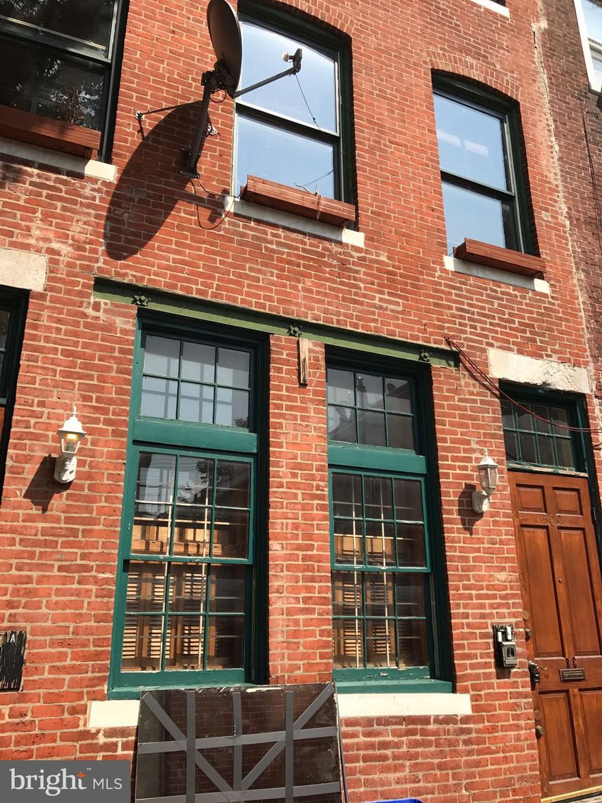 SOCIETY HILL/SOUTH ST. Beautiful, 2nd floor, 1 bed 1 bath apartment! Located on quiet S. Reese St., tucked between Lombard and South and 5th and 6th. The building is pre-industrial, all brick 1840c, architecturally designed by Richard Gelber, AIA design partner & founder of SPG3. The front living space has three huge east facing windows taking in the afternoon sun, making it very bright and cheery. It also features a wood burning fireplace on a platform that is the focal point for the room. The bedroom is located in the rear off the street with a full bathroom attached. There's a linen closet and a bathtub in the spacious bathroom. A portable air conditioner is located in the living room and a wall unit in the bedroom with sliding glass doors. Coat closet located inside the front door. A conveniently located laundromat is around the corner on 5th St. and coffee shop on the corner of 6th and Lombard. Half a block north of South St. Walking distance to Center City, Washington Square, Pennsylvania and Jefferson Hospitals.