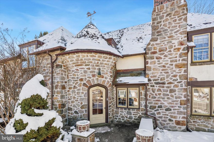 A rare expression of craftsmanship and character, this circa-1920 French Normandy residence showcases architectural integrity seldom found in today’s homes. From the moment you enter, slate flooring, graceful archways, and preserved period details set the tone for a home that feels both storied and inviting.

The foyer unfolds into a series of intimate yet connected spaces, where built-in corner cabinetry, a charming reading nook, and original architectural accents create warmth and authenticity. The living room is anchored by one of two stone fireplaces and opens through French doors to a covered porch—an effortless extension of indoor-outdoor living, ideal for entertaining or quiet evenings at home.

The kitchen blends classic elegance with modern function, featuring granite countertops and generous workspace suited for both everyday living and hosting. A formal dining room offers an elegant setting for gatherings, while four bedrooms, two full baths on the upper level, and a first-floor powder room preserve the home’s era-appropriate charm with thoughtful livability. Thoughtful original features continue to elevate the home’s character, including a functioning laundry chute that speaks to the home’s historic design and enduring practicality.

The finished lower level adds approximately 600 square feet of versatile living space with laundry room—ideal for a media room, home office, gym, or additional entertaining area—enhancing both functionality and lifestyle appeal.

The exterior is as captivating as the interior, a true expression of French Normandy charm enhanced by artisan craftsmanship. A gently winding stone walkway leads to a distinctive, character-rich front entry, offering a preview of the architectural elegance found throughout the home. Carefully curated details—including a storybook wishing well, a weather vane integrated into the stone façade, copper flashing, and three porches (two covered)—create a sense of old-world romance and authenticity rarely achieved in modern construction.

The stone exterior, mature landscaping, and layered outdoor living spaces provide both visual drama and everyday functionality, making the home feel equally refined and welcoming from every angle. Positioned on a desirable corner lot with a two-car garage with EV charging outlet and expansive driveway, the property is framed by mature trees in a quiet residential setting.

Located within the Boyertown Area School District and just a short walk to Boyertown’s seasonal downtown events and local farmers market. Additionally, the home offers convenient access to local shops, dining, and attractions, including Frecon Farms and the popular Colebrookdale Railroad.

More than a home, this is a rare opportunity to own a piece of architectural history—beautifully maintained and thoughtfully updated for modern living. Homes of this caliber rarely change hands. Schedule your private showing today.