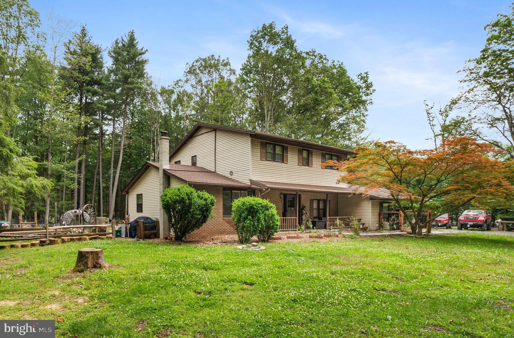 Are you an outdoor enthusiast or love to cook? This home is for you! With your own greenhouse, plentiful raised garden beds and outdoor kitchen including a Pizza oven, creating fresh meals will be a breeze. Expanded kitchen with center island, stainless steel appliances and an abundance of custom storage is a chef's delight. Enjoy the spacious eat-in kitchen, open to a family room with French doors to the outdoors, plus second living room and dining room for plenty of space to entertain. The fenced-in backyard is bright and open, with a sunken fire pit area, covered deck with built-in island and kitchen storage all on 1 acre with NO Hoa. Inside has vinyl flooring throughout, updated bathrooms, and a woodstove in each living room to keep utility bills low and stay cozy in the winter, plus generator hookup. The Primary Bedroom upstairs features your own en-suite bath. Main floor powder room and laundry in the spacious mudroom is a great added space, in addition to the fully finished lower level with an outside entrance. A 2 car attached garage and plenty of parking with a circular driveway! Ask how to receive a $3,000 lender credit towards closing costs or lowering your interest rate!