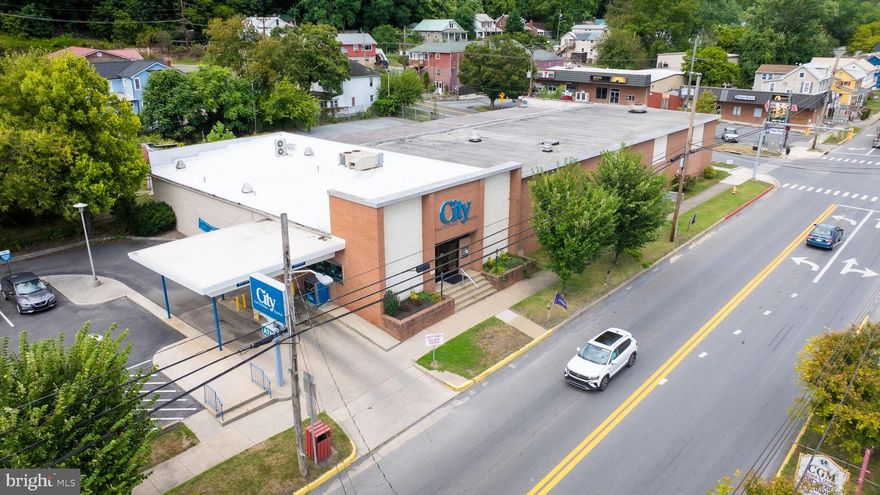 HUGE PRICE REDUCTION....Don't wait too long...Our small town is growing and here is your opportunity to go with the flow and grow with the growth of our beautiful town of Berkeley Springs.  Multi- use for this building located on the corner of Union and Washington street with over 8000 square feet of space that is producing income as you are reading this. The two tenants, City National Bank and Berkeley Springs Brewery Co. has signed a lease with current owner..
So many ways to use this huge, spacious building to produce income., use your imagination and give us a call.  4 lots that total .73 of an acre conveys with this sale.