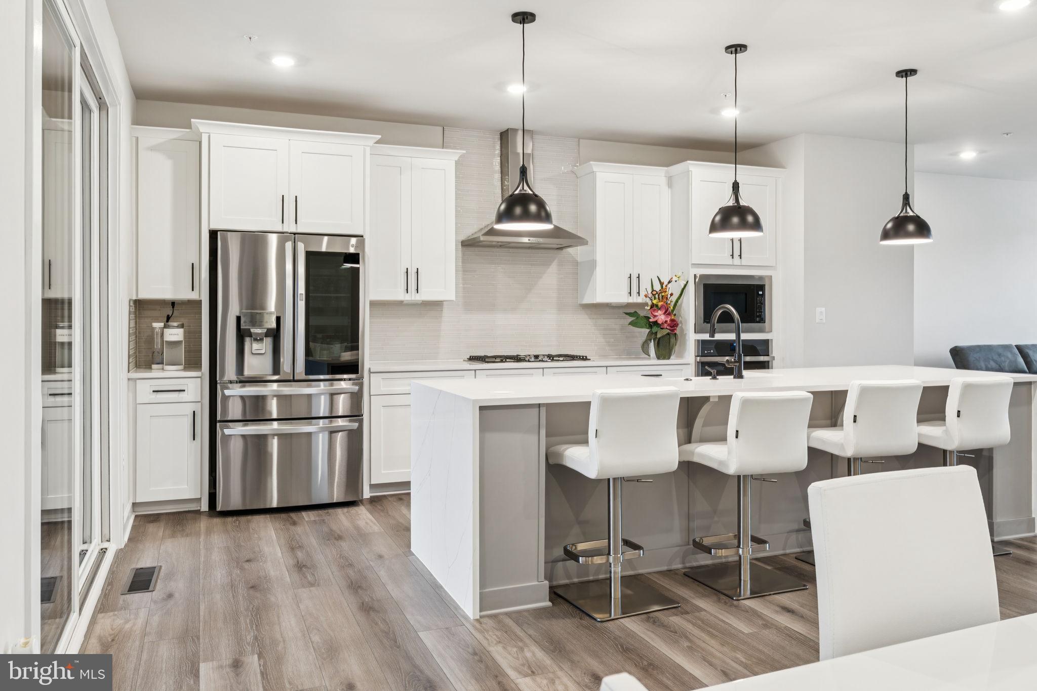 $110,000 WORTH OF OPTIONS & UPGRADES featured in this lightly lived in 2,894 square foot Woodley Park model!
Enter either thru your 2-car garage or sleek front door where luxury vinyl plank flooring welcomes you to your practical entry way featuring a convenient mud room bench, powder room and lower-level recreational room that looks out to your wooded serene oasis.
The glamorous, gourmet kitchen presents a stunning 4-seater Quartz waterfall edge island with overhead pendant lighting and farmhouse sink. The beautiful, glass, mosaic backsplash is the backdrop of the generous energy efficient stainless steel appliance package: LG Thin Q refrigerator, range hood w/36" wide 5-burner gas cook top, built-in microwave & wall oven and dishwasher. Several, additional kitchen conveniences include high-end touch faucet, garbage disposal, island pop-up electrical outlet, soft close drawers/cabinetry and tucked away pantry.
Walk into your eye-popping primary bedroom with tray ceiling, walk-in closet and ensuite spa-like luxury bathroom. Bath features double sink Quartz countertops, upgraded tile in the oversized bench shower with dual shower head/mechanics, and water closet. Natures wooded view is the background to these private spaces of yours.
Just outside of the primary suite is the conveniently placed laundry room containing the energy efficient LG front loading washer/dryer set. Bedroom 2 w/balcony & walk-in closet, Bedroom 3 w/walk-in closet and hallway bath containing double sink Quartz countertops and bench shower with upgraded tile complete this level.
Extend your entertainment space onto your nearly new composite deck featuring a remote-controlled automatic screen to separate the patio space that features a stylish, stone fireplace and ceiling fan.
Custom window blinds and recessed lighting throughout. Ceiling fans w/remotes in each bedroom.
"Extra, Extra. Read All About It!"... Garage stainless steel GE refrigerator, Deck & Patio furniture sets (2) w/Propane fire pit table & Umbrella, Charcoal grill, 2nd bedroom Cafe patio set & Wall mount TV brackets. Bonus: Home Warranty :-)
CHECK OUT RECENTLY SOLD PROPERTIES IN THE COMMUNITY THRU PUBLIC RECORDS!
13845 Hunt Valley Ct - $848,799 - 12/16/24, 13825 Hunt Valley Ct - $812,758 - 04/23/24, 13831 Hunt Valley Ct - $804,539 - 04/08/24, 13817 Hunt Valley Ct - $797,113 - 04/18/24, 202 Hickory Hollow Ct - $793,128 - 12/19/24