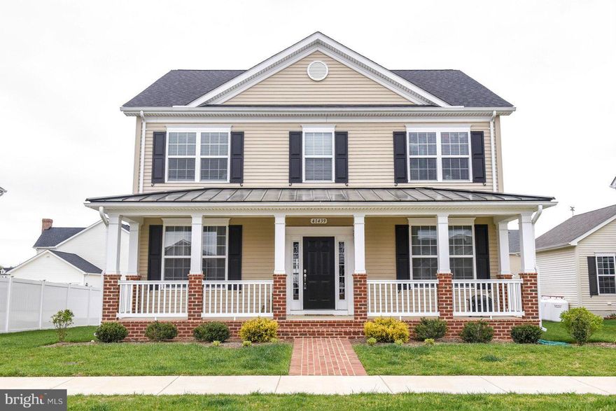 Colonial with brick walkway leading up to full front porch.  Beautiful 4 bedroom 3 and half bath with open floorplan. Gourmet Kitchen w/ granite and SS appliances. Huge center island. Hardwood floors, gas fireplace.  Large master suite with grand bath. Basement includes Media room, rec room with 4th bedroom, full bath and separate storage rm.  Enjoy community pool & clubhouse.