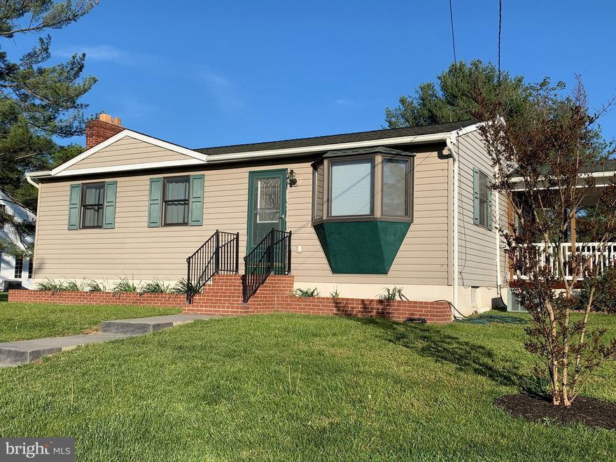 A perfectly adorable rancher in the heart of Perry Hall on a .38 acre level lot.    The 32' x 28' garage has two 10'x10' doors for your oversized vehicles, boat storage, or those messy hobbies.  Enjoy summer evenings on the covered side porch or rear deck overlooking the lovely landscaped perfectly level lot.  The wood floors are gleaming throughout the main level and the doors and trim are natural wood finish.  There is a large eat-in kitchen w/ stainless steel appliances and access to that side porch.    The lower level is mostly finished with a large recreation room, wood-burning fireplace, and office.