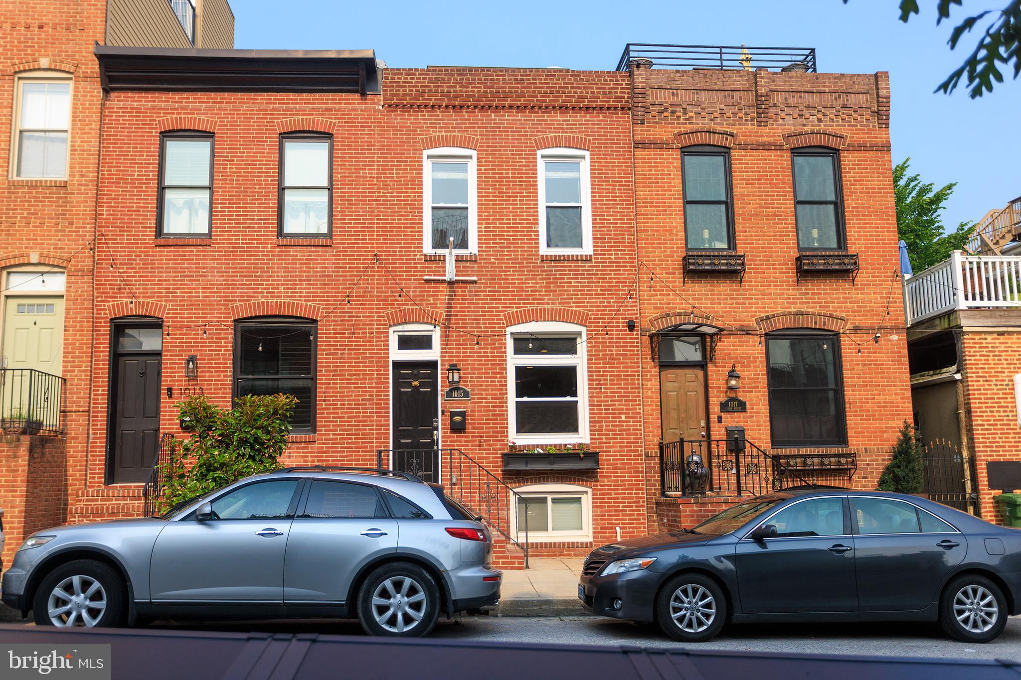 Open House Thursday before First Thursday 4:30-6
Nestled in the heart of Canton just steps from O'Donnell Street, this beautifully maintained two-bedroom, one-and-a-half-bath home blends classic Baltimore character with modern updates and unbeatable walkability to shops, restaurants, and nightlife. Step inside to charming exposed brick, 9' ceilings, and hardwood floors that flow throughout the main and upper levels, all complemented by a fresh coat of paint and floating staircase adding to this open layout. The main level features a convenient half bath and a stylish dry bar with surrounding cabinetry—perfect for entertaining and additional storage. To the rear the kitchen shows off granite countertops, stainless steel appliances, and brushed nickel finishes, leading to a private rear patio with vinyl fencing, landscaped flower beds, and private gated alley access. Upstairs, you'll find two spacious bedrooms with custom closets that share a full hall bath recently updated with clean, modern finishes. Finally the finished lower level offers flexible space for a third bedroom, office, or rec room, while the rear utility area provides full laundry and bonus storage cabinets. This won't last so set up a showing today!